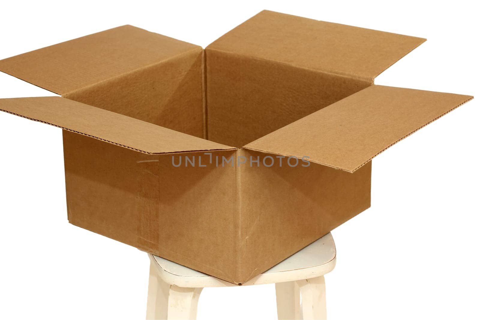 Rectangle cardboard box on beige stool for creative arts and toy storage.