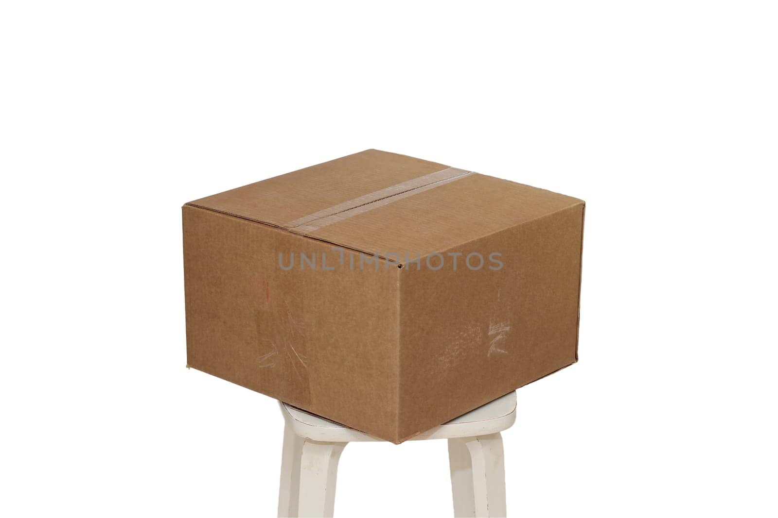 Rectangle cardboard box on beige stool for creative arts and toy storage.