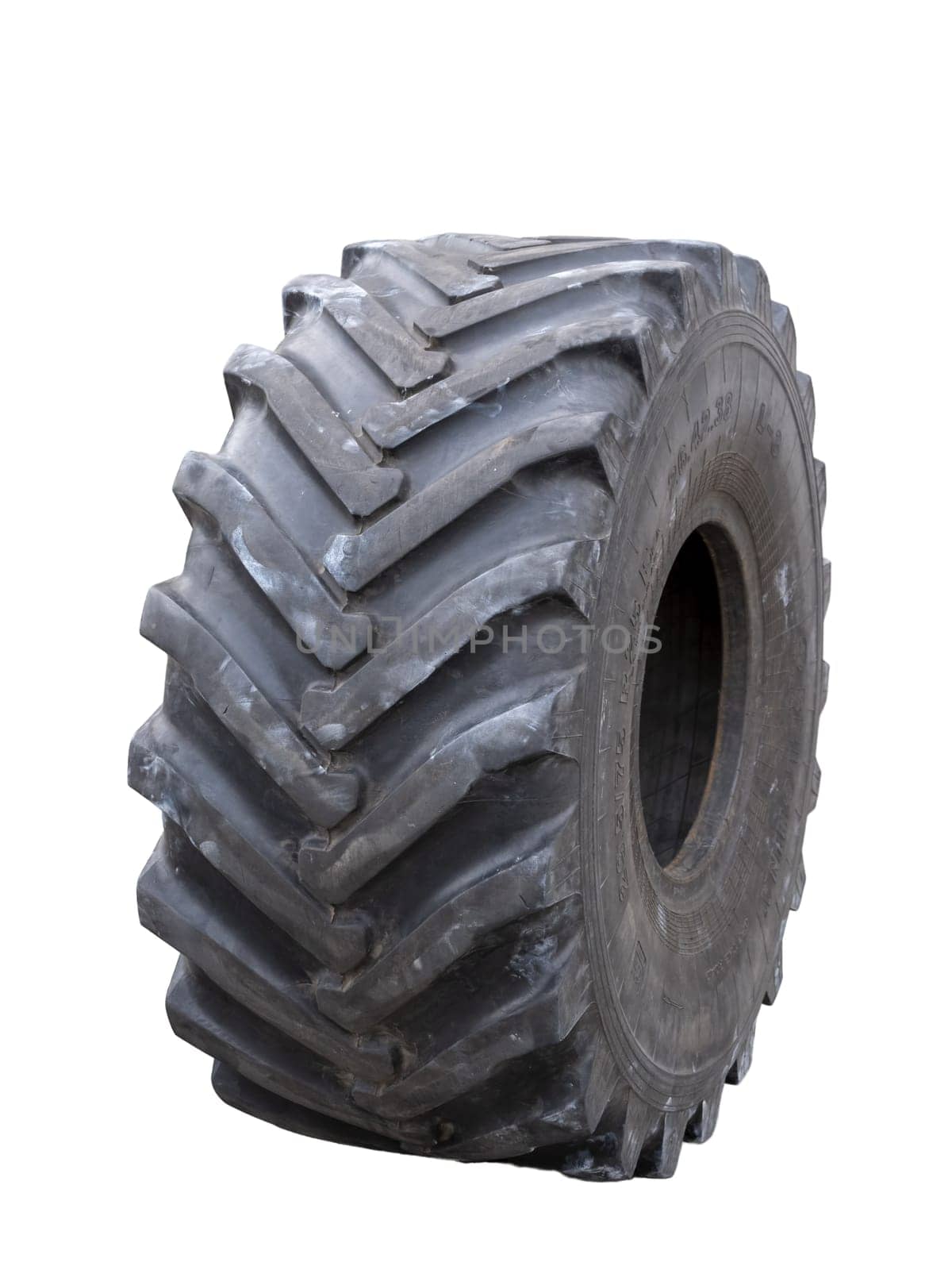Close up of a tire with intricate tread pattern on white background.