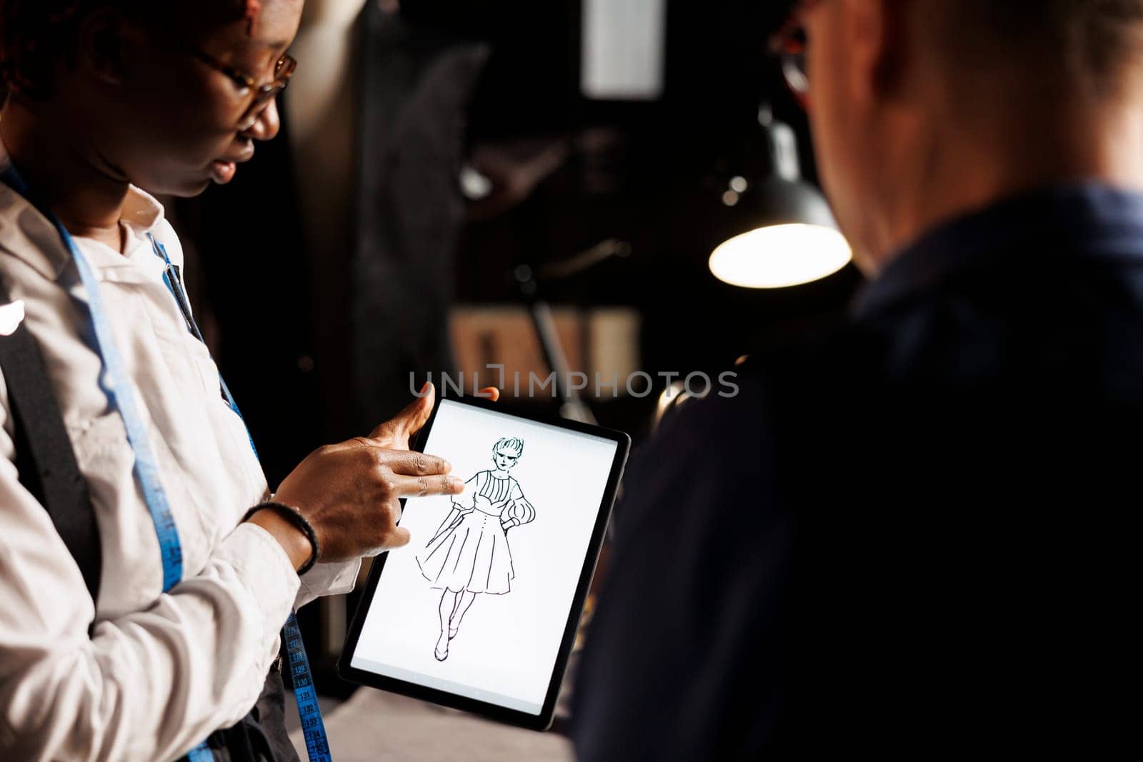 Designer showing atelier manager sketch by DCStudio