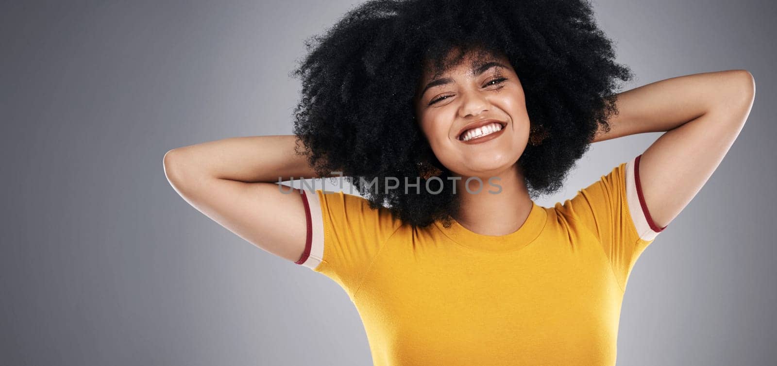 Woman, clothes and portrait of fashion, fun and smile for banner, stylish and confidence of girl. Afro, happy and female model in black background, pride and hair for person, cheerful and studio by YuriArcurs