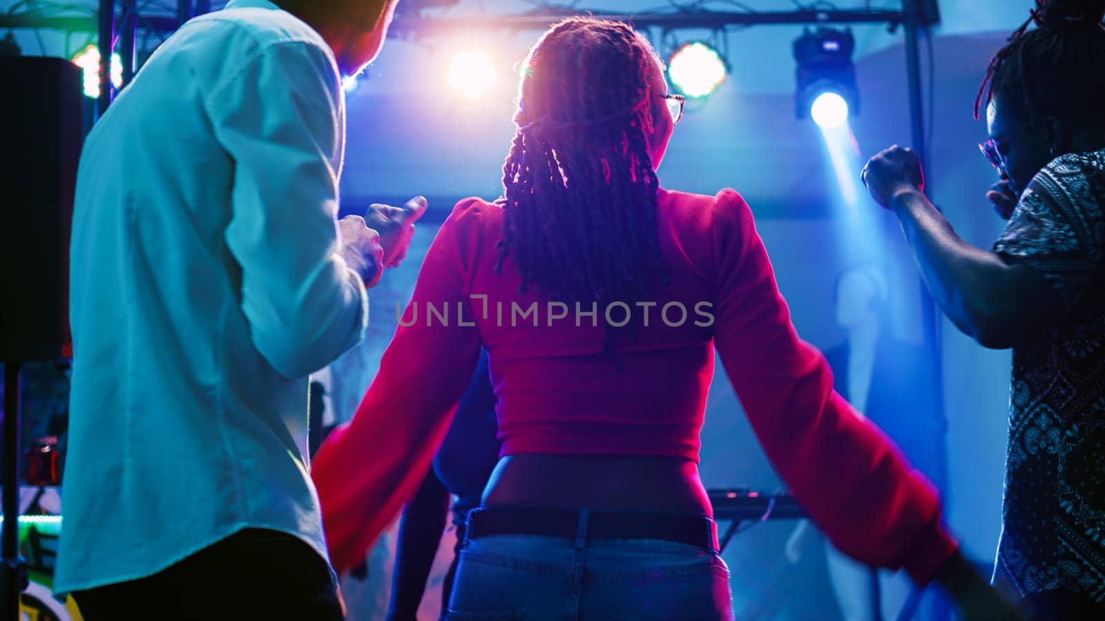 Men and women dancing at nightclub by DCStudio