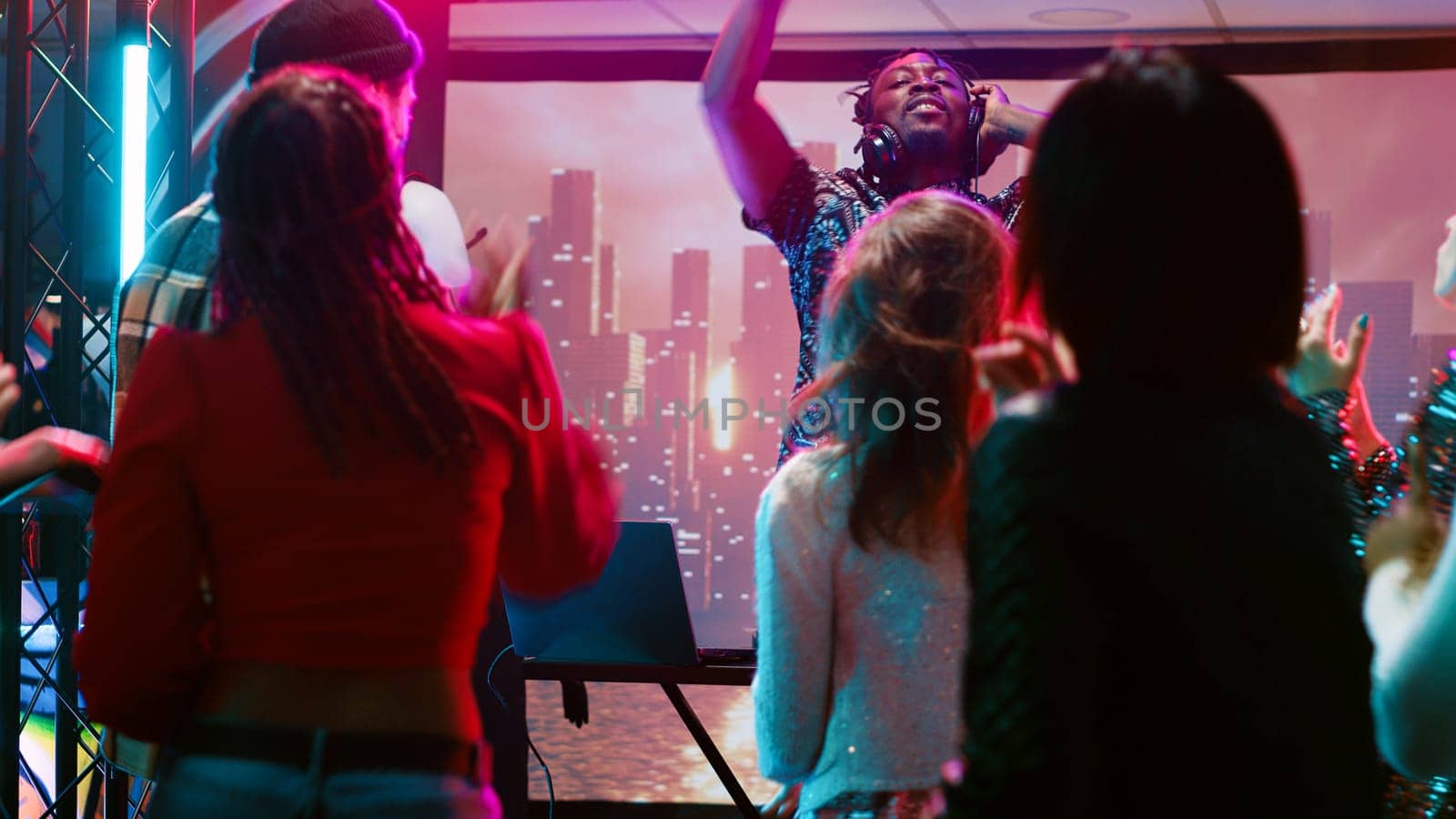 Young man clubbing with people at bar by DCStudio