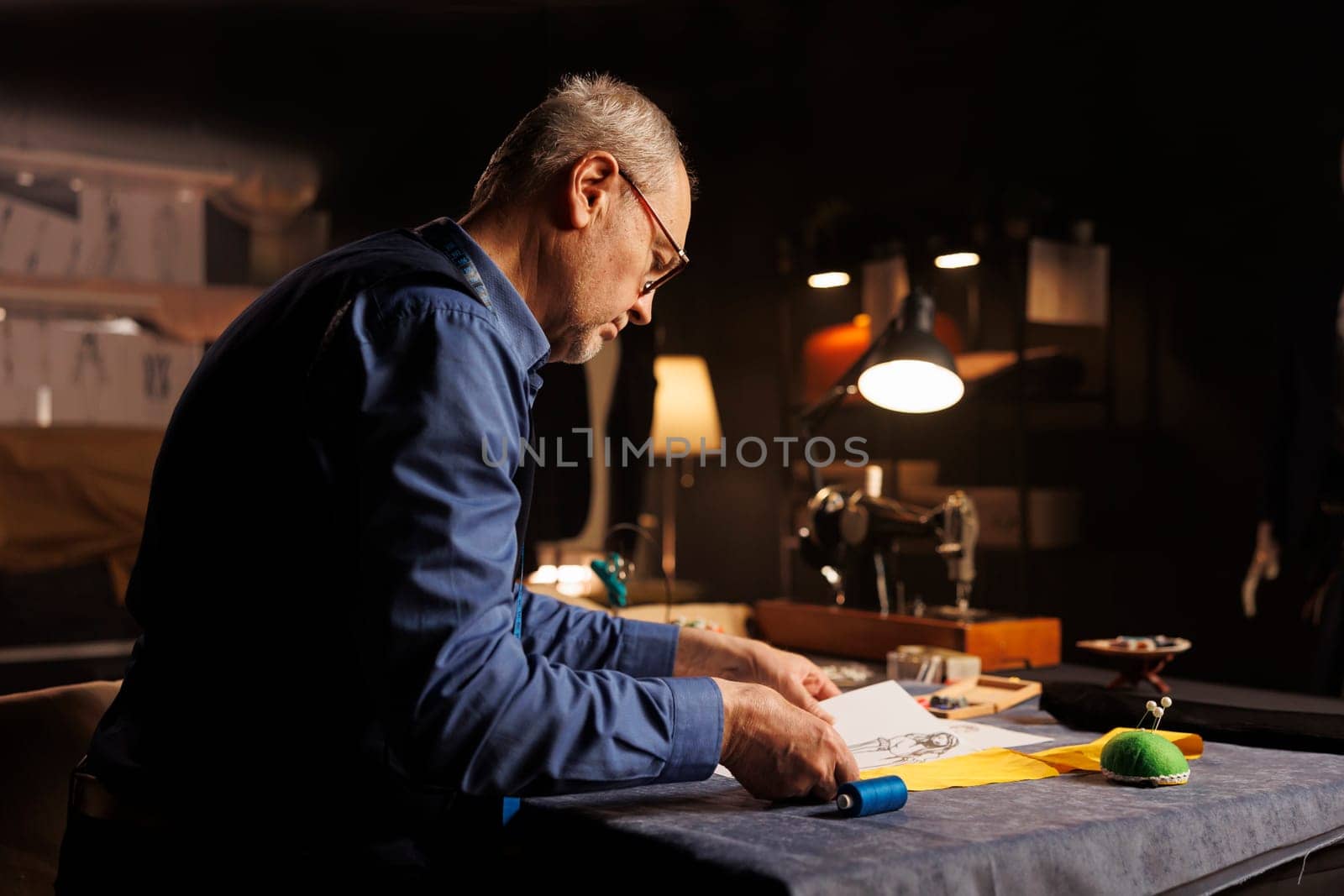 Dressmaker working with sewing materials by DCStudio