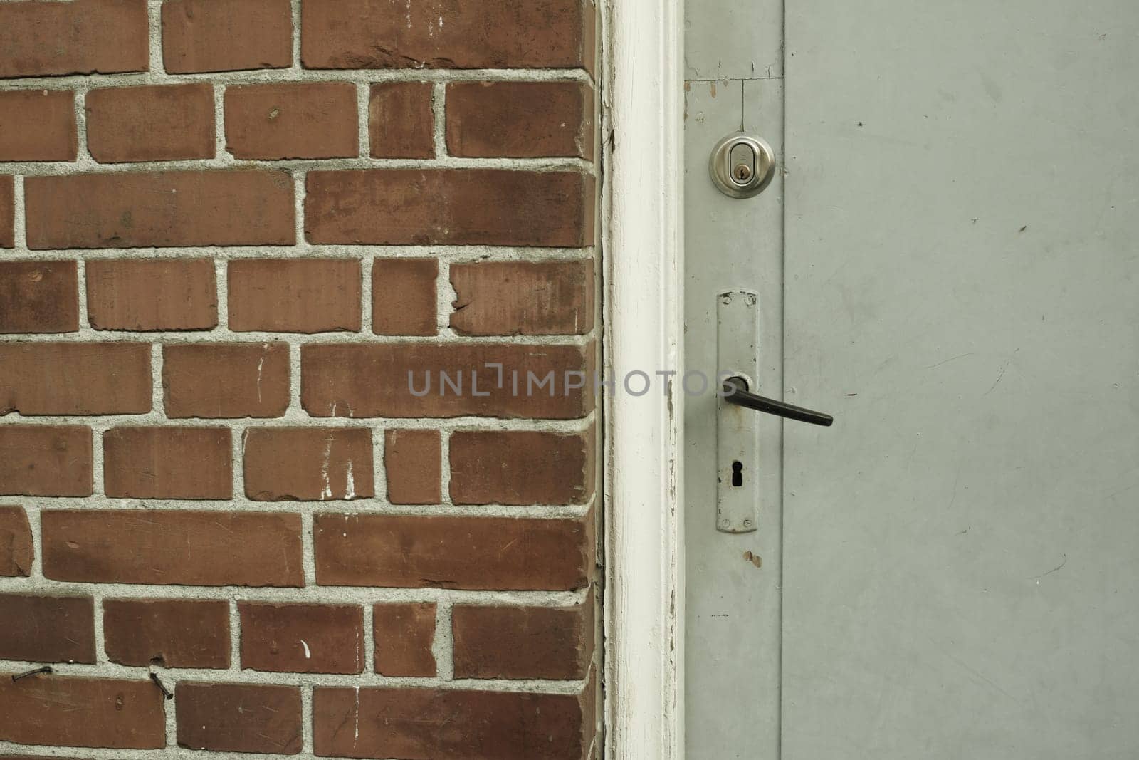 Brick wall, door and building in urban area for design, texture and architecture for construction. Concrete, pattern and vintage structure for development, exterior and maintenance in old town