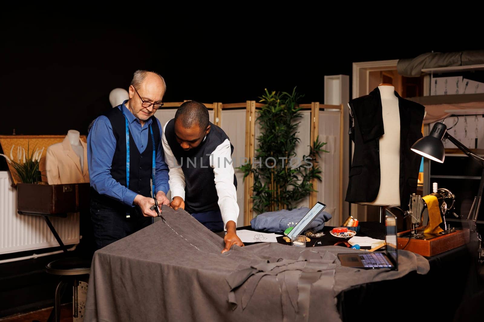 Skilled craftmanship in tailoring studio by DCStudio