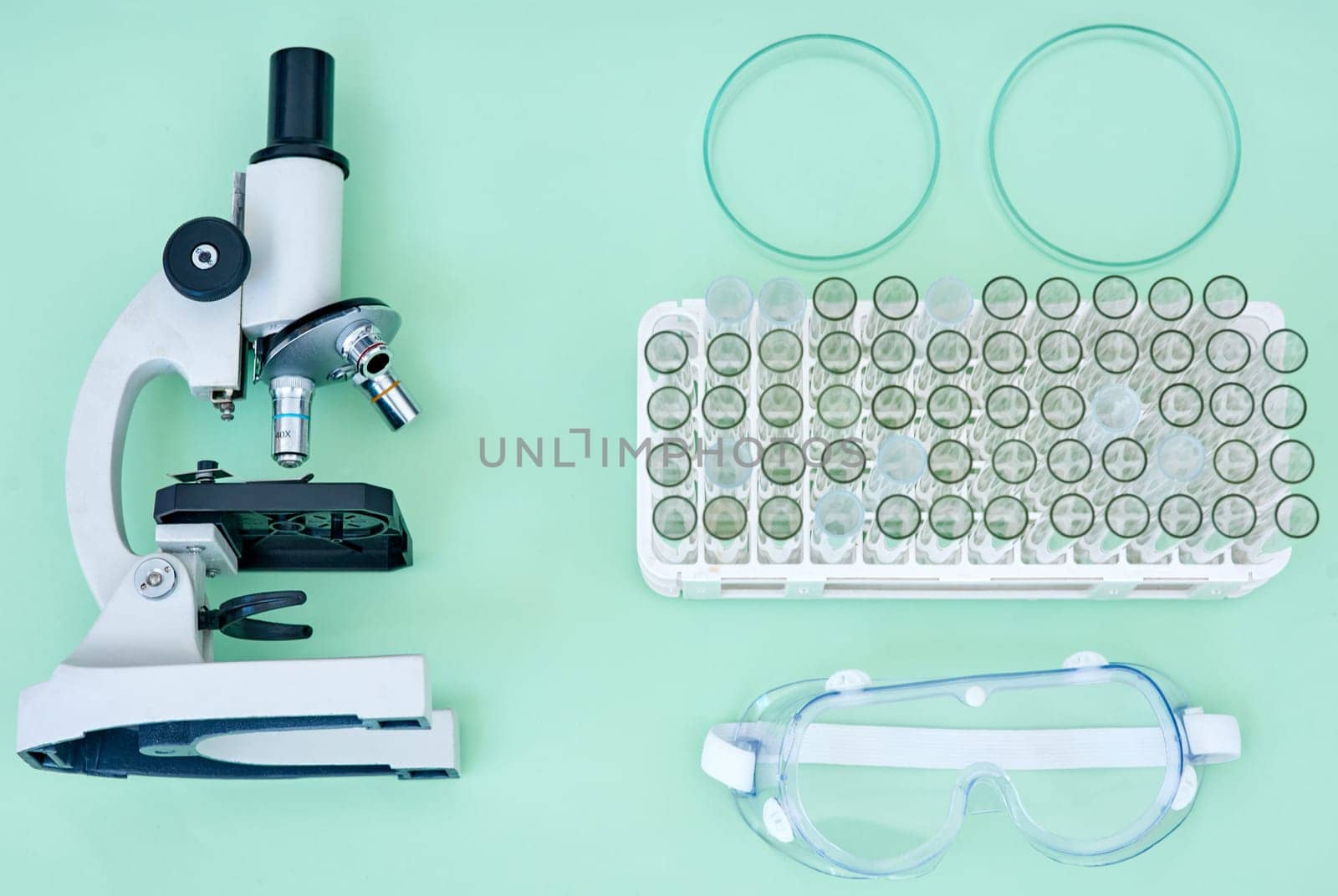 Lab, tools and collection of equipment with microscope, test tube and safety goggles for medical research. Science, medicine and laboratory supplies for pharmaceutical study on studio background. by YuriArcurs