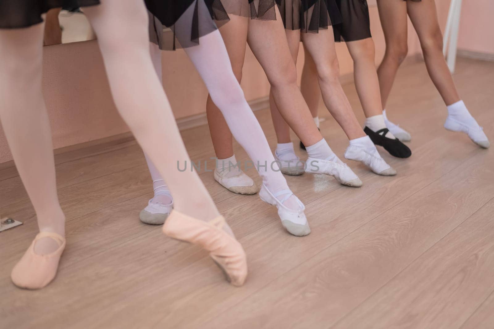 Close-up of feet of 5 little girls and teacher at ballet class. by mrwed54