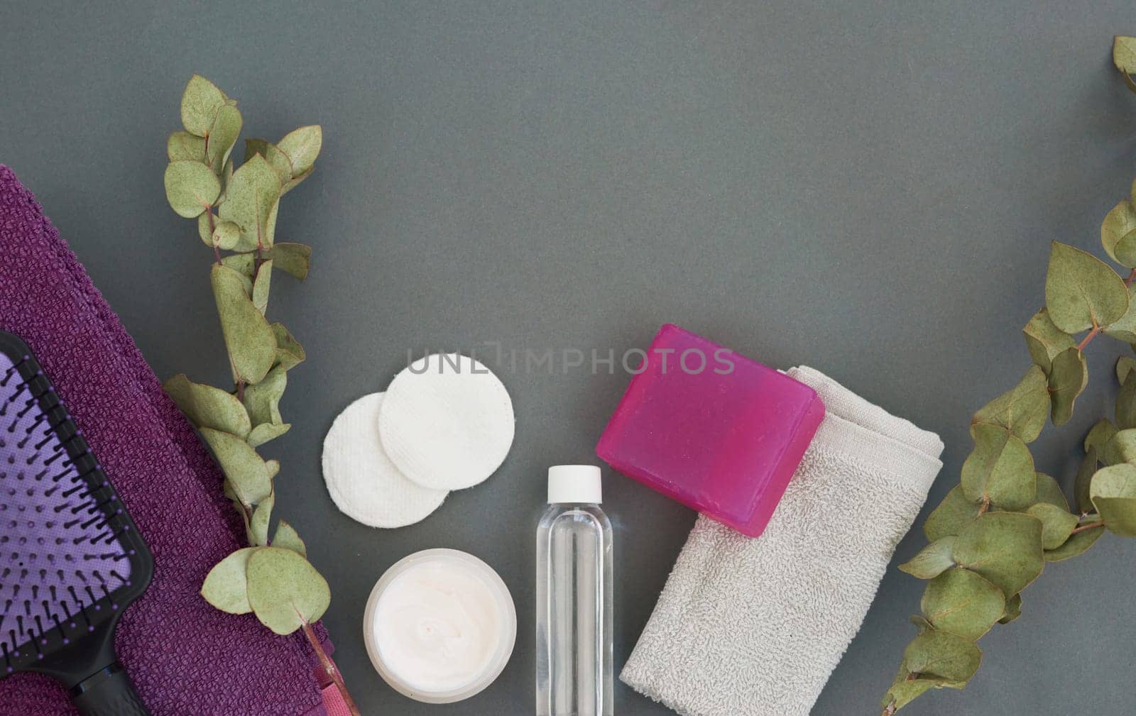Spa, beauty equipment and above with skincare, eco friendly and cruelty free treatment products. Cosmetics, soap and natural fiber cloth for washing and shower routine with grey background and plants.
