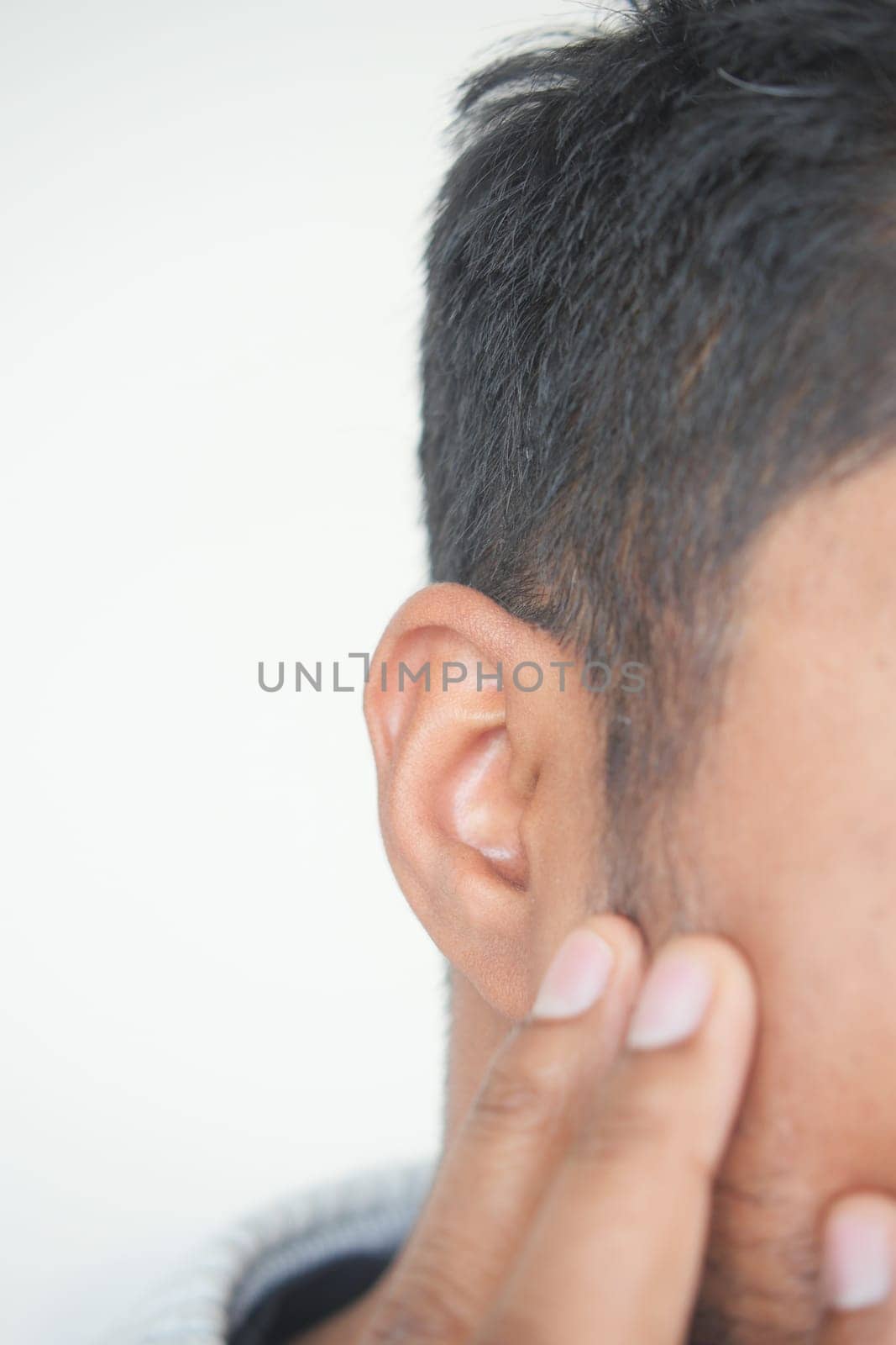 young man having ear pain touching his painful ear