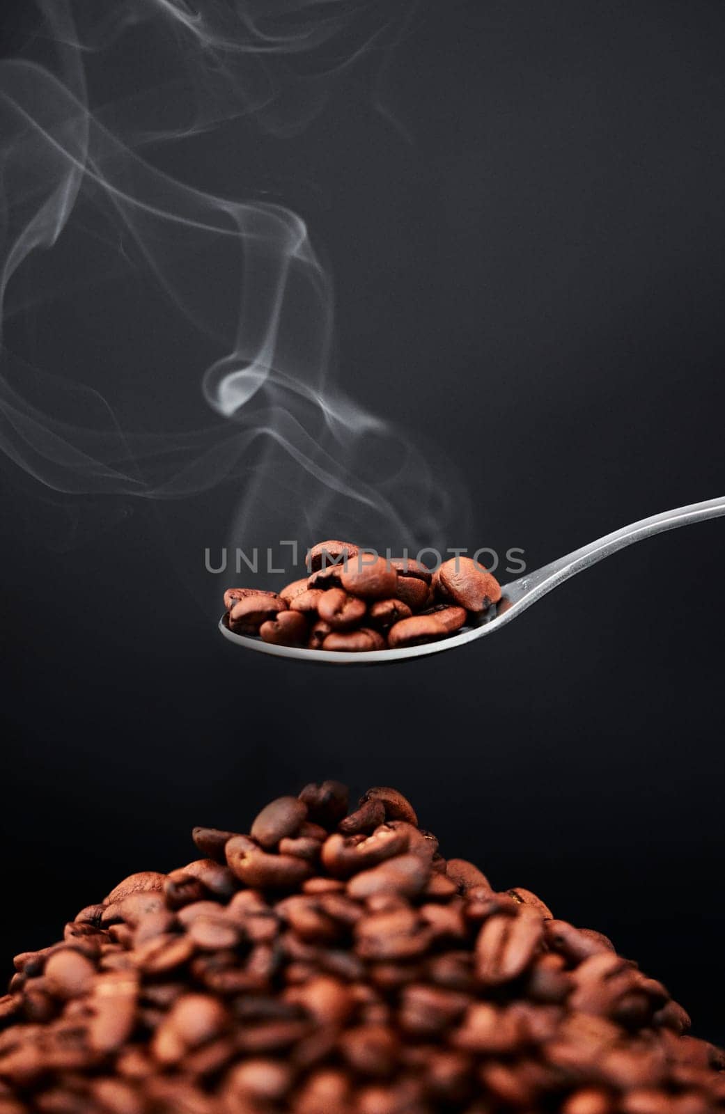 Studio, coffee beans and smoke aroma on spoon or organic diet, roast flavor and black background. Art, seeds and texture of raw ingredient for espresso or scent, cappuccino and steam on mockup space.