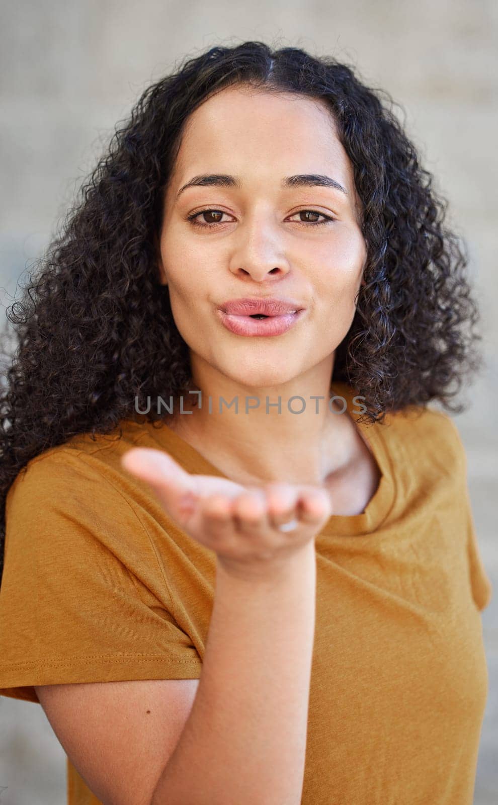 Woman, portrait and blowing a kiss for flirting, love and romance with cute gesture for relationship. Confidence, happy and emoji with lips or mouth, emotion and expression of feelings for affection by YuriArcurs