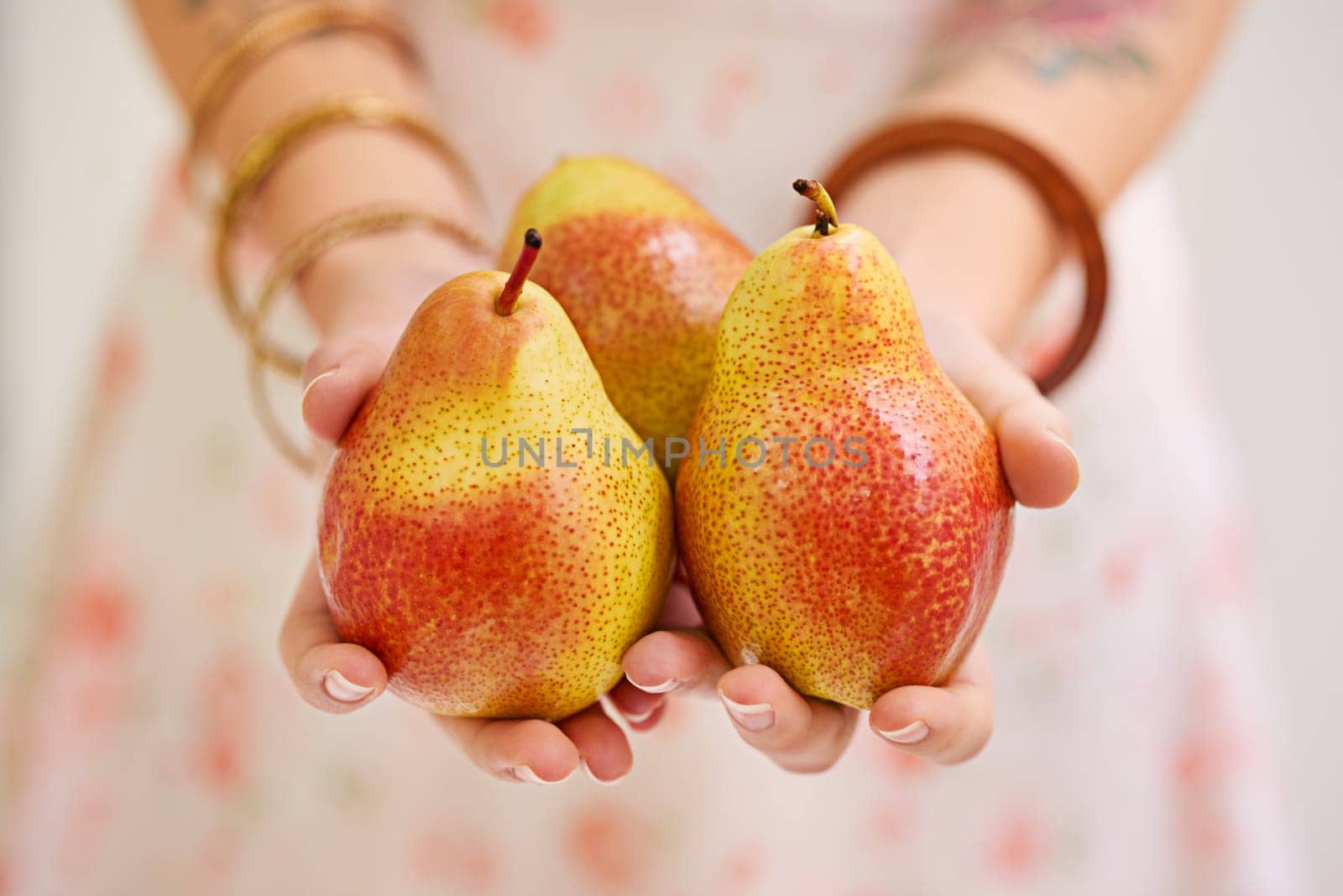 Woman, hands and fruit or pears for health, organic and balanced diet by eating nutrition snacks. Person, fresh and wellness with natural ingredients for vitamin from farming at green plantation.