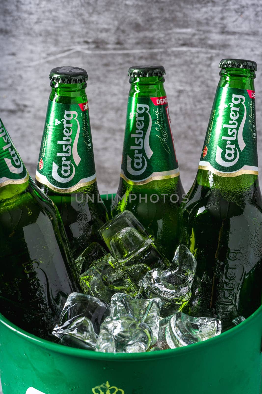 Antalya, Turkey – April 4, 2024: Carlsberg Beer bottles in bucket with ice by Sonat