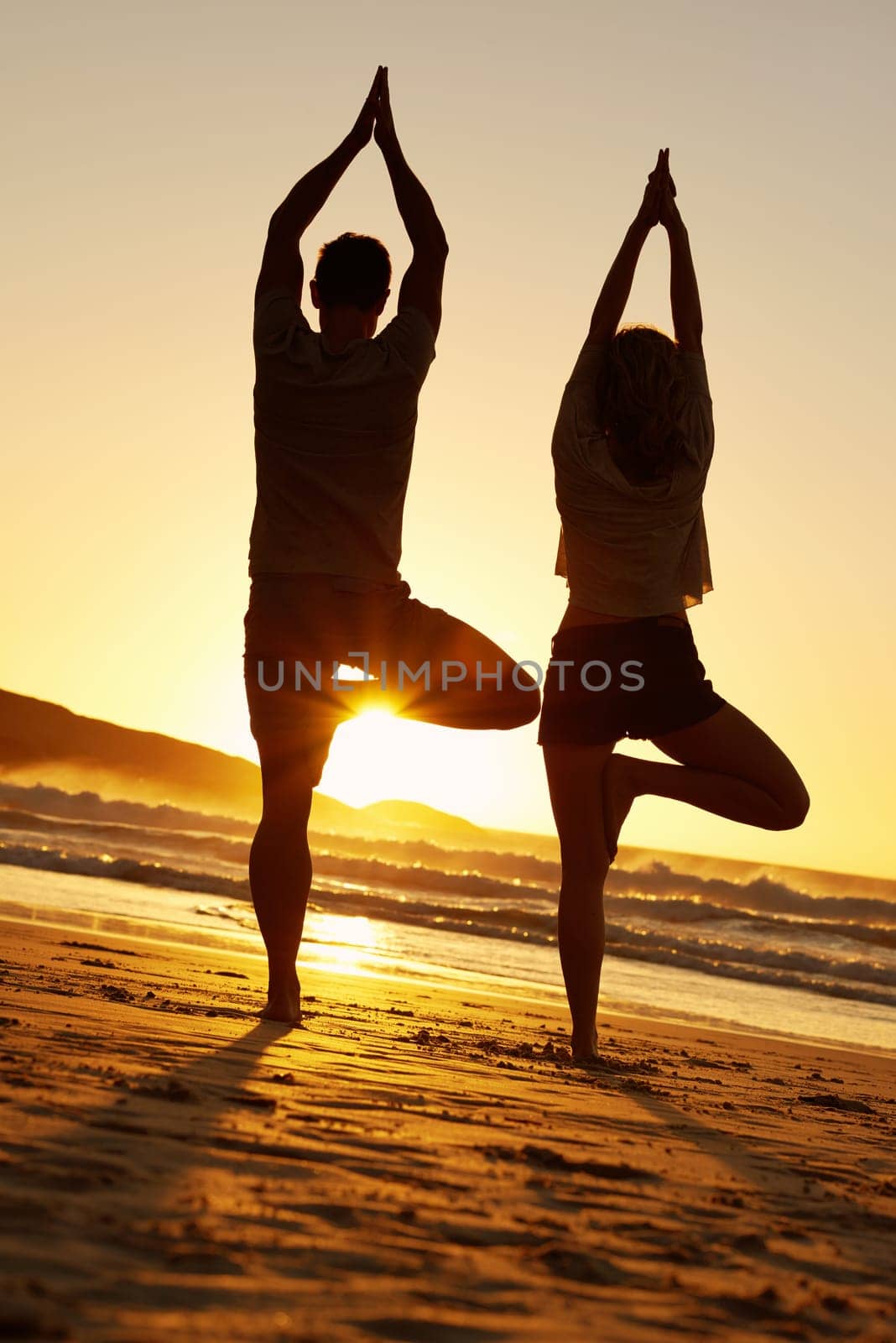 Healthy couple, silhouette and yoga on beach for fitness, meditation and sunset in summer for holiday. Man, woman and waves in tropical island for zen, sundown and mindfulness in nature for peace.