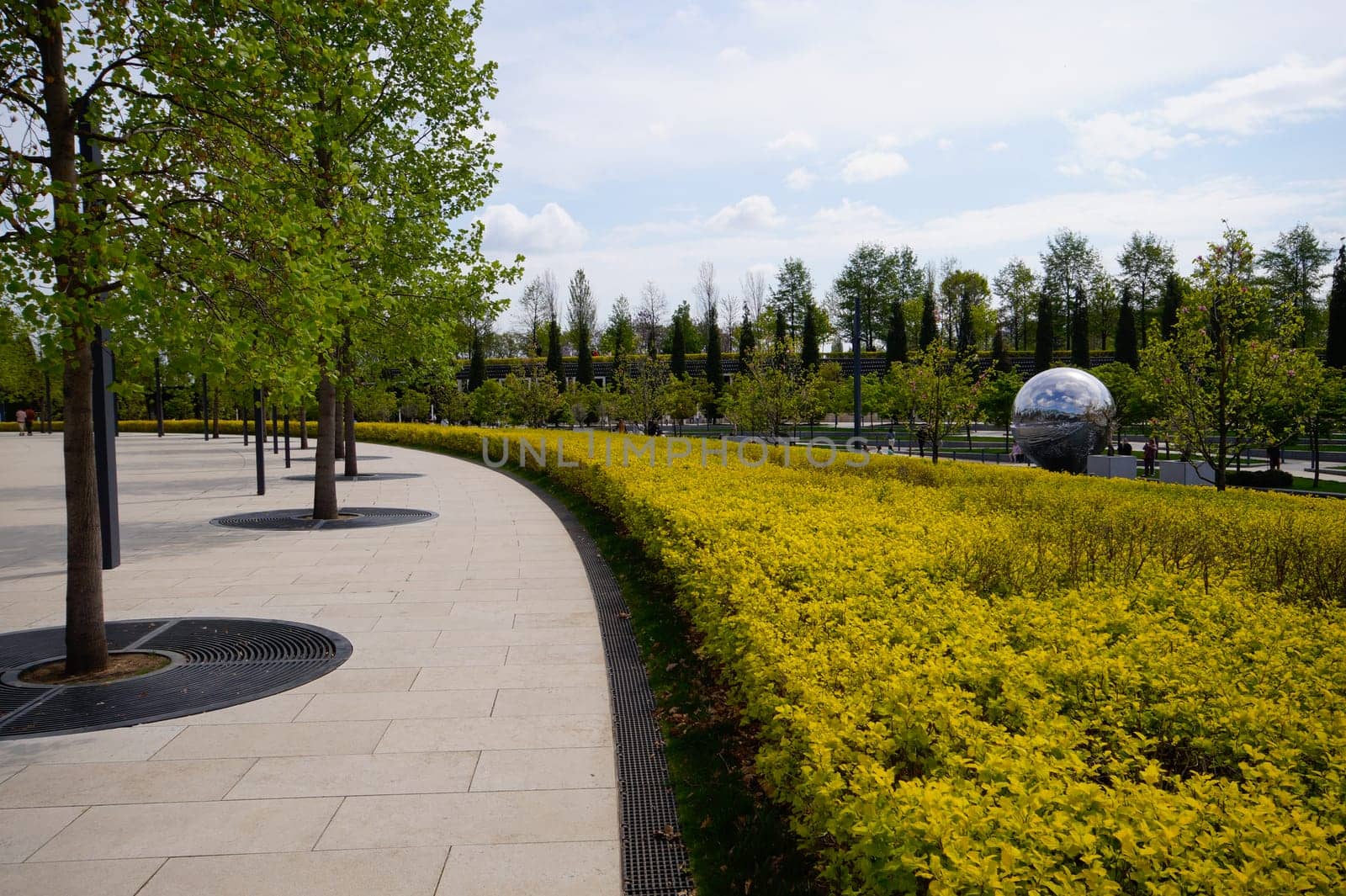City park Krasnodar. Concrete path in the park. Urban environment.