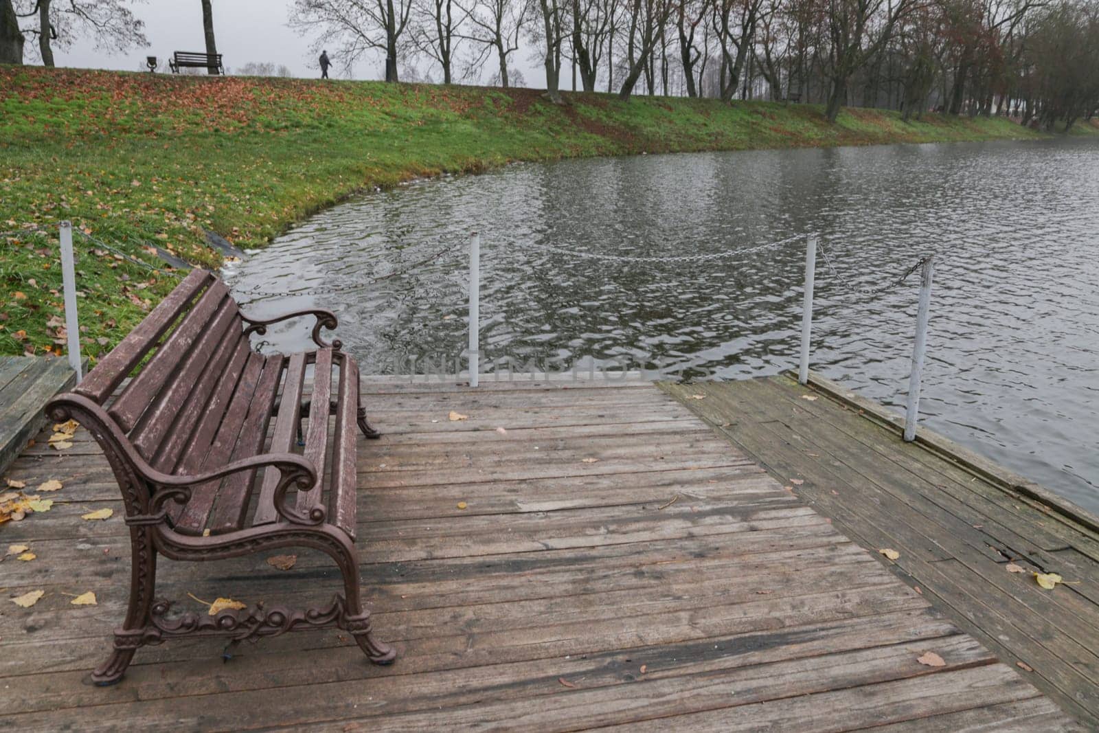 Wooden pier on the background of the lake, autumn. Place for fishing, rural recreation, camping.