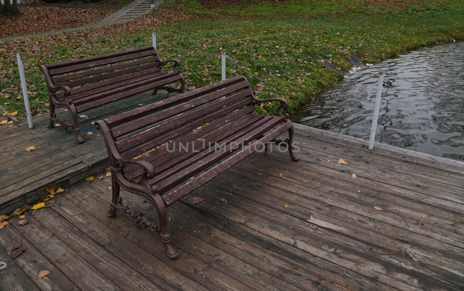 The benches on the wooden village pier. A place to rest on the bank of the river.