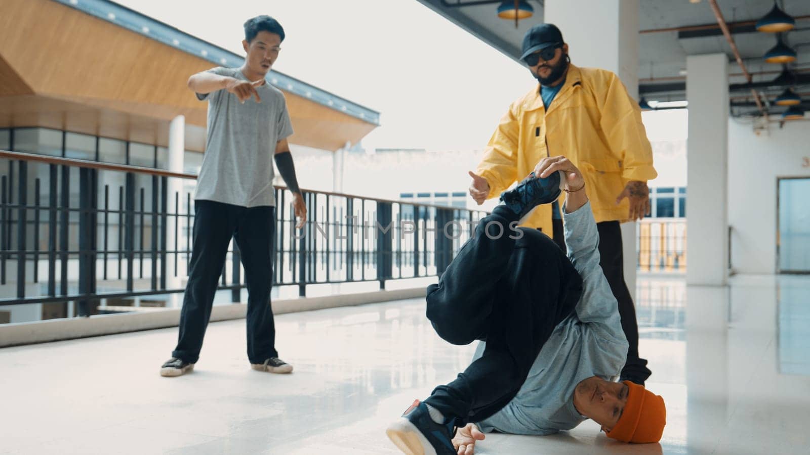 Hip hop team dance break dance while multicultural friend surrounded and clapping hands to cheer or encourage his friend to dance. Active and energetic street dance. Outdoor sport 2024. Endeavor.