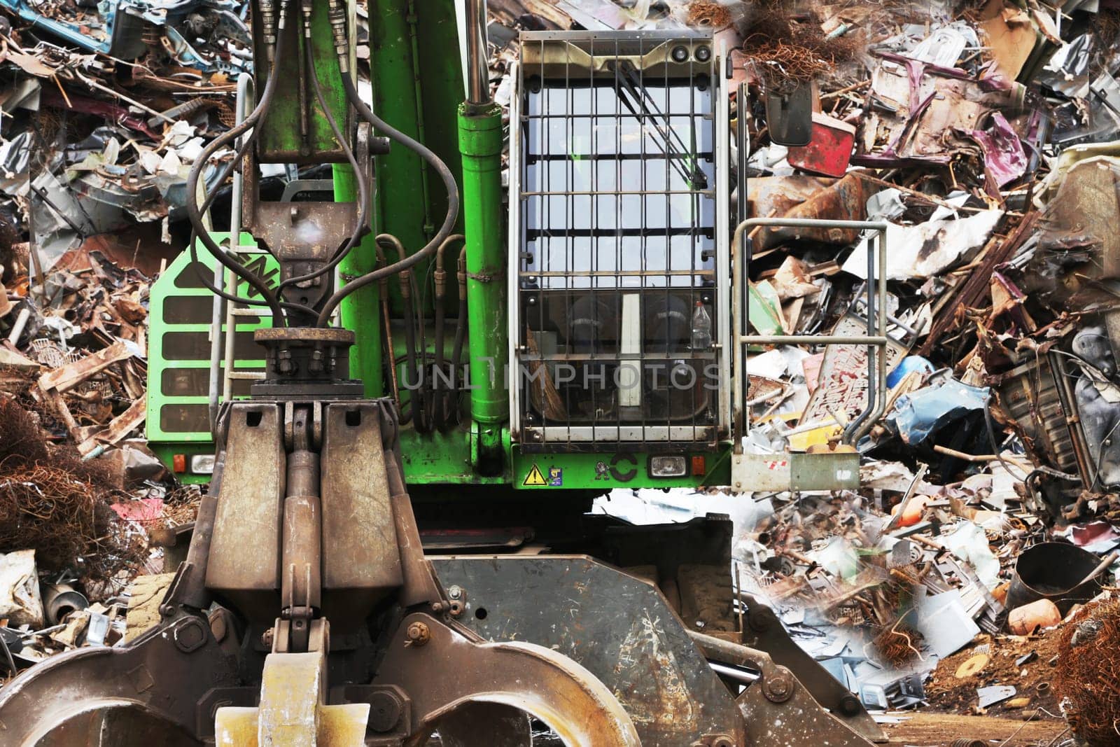 Close-up of a crane crane against the backdrop of a scrap metal dump. by gelog67