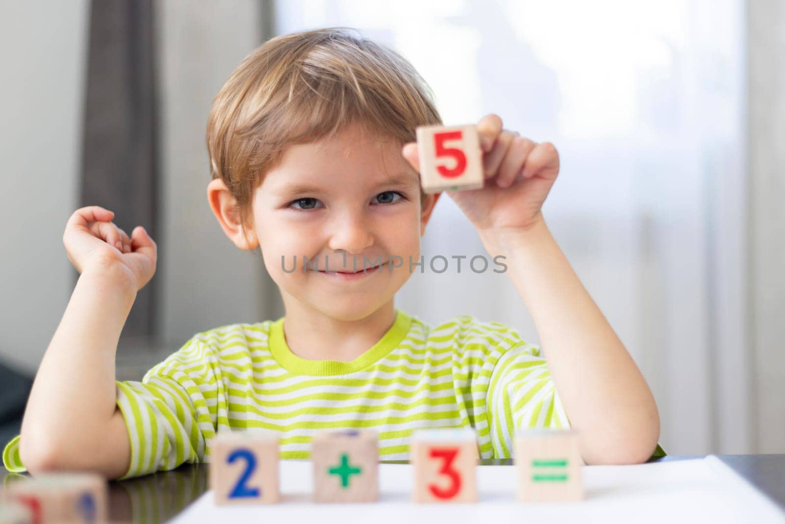 Boy Showing Number Five with Blocks by andreyz