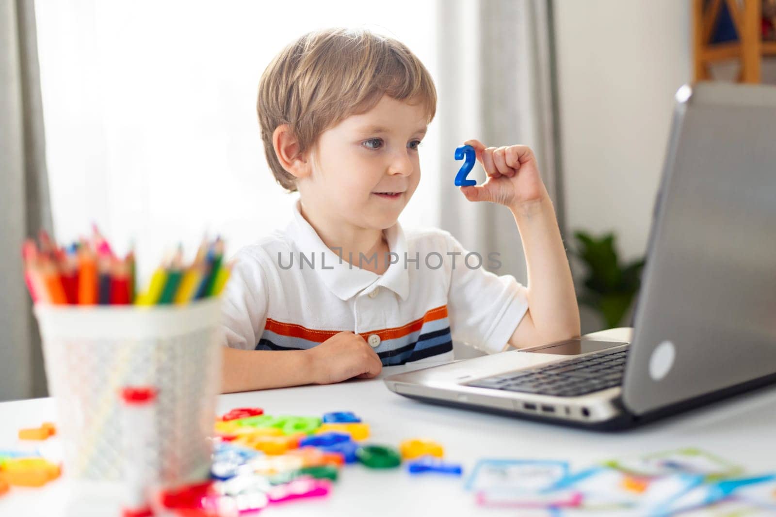 Boy Learning with Laptop and Educational Toys by andreyz