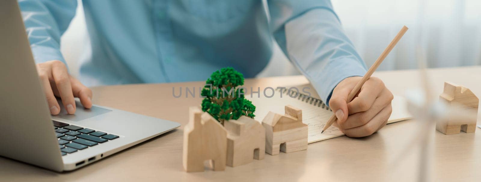 Windmill model was holding by skilled businesswoman while she start represented about benefit of using renewable energy for green business on the meeting table. Closeup. Delineation.