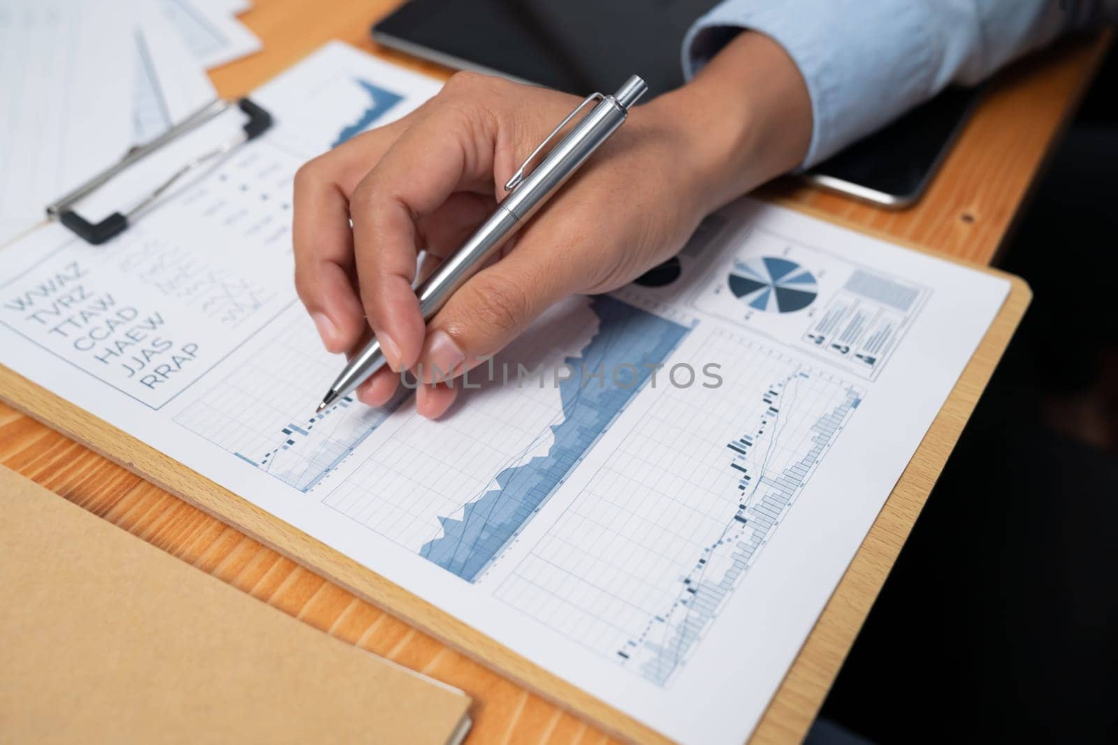 Diverse group of business analyst team analyzing financial data report paper on office table. Chart and graph dashboard by business intelligence analysis for strategic marketing planning Habiliment