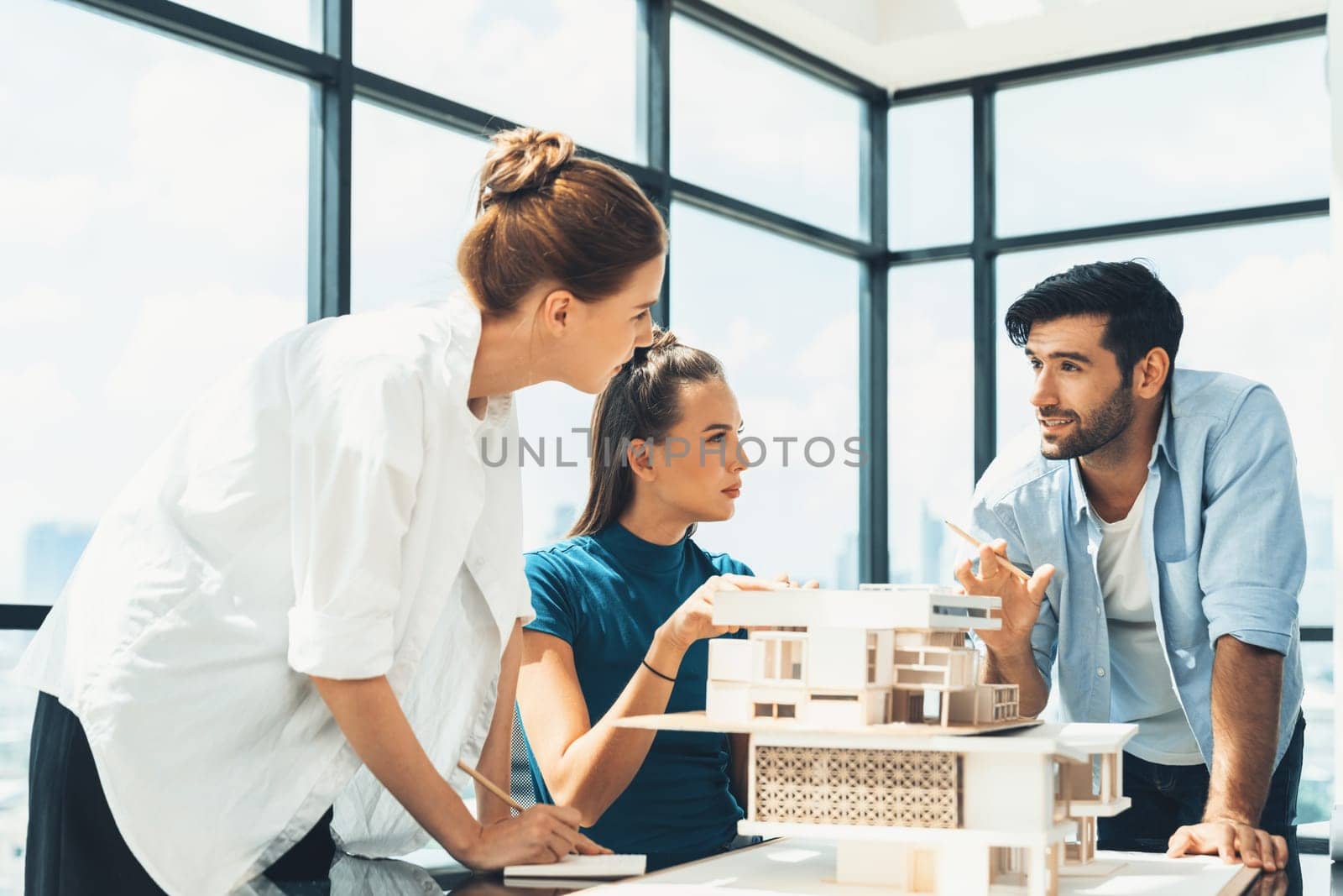Professional diverse architect engineer team working together to design house model. Group of successful business team discussing and brainstorming about house structure. Civil engineering. Tracery.