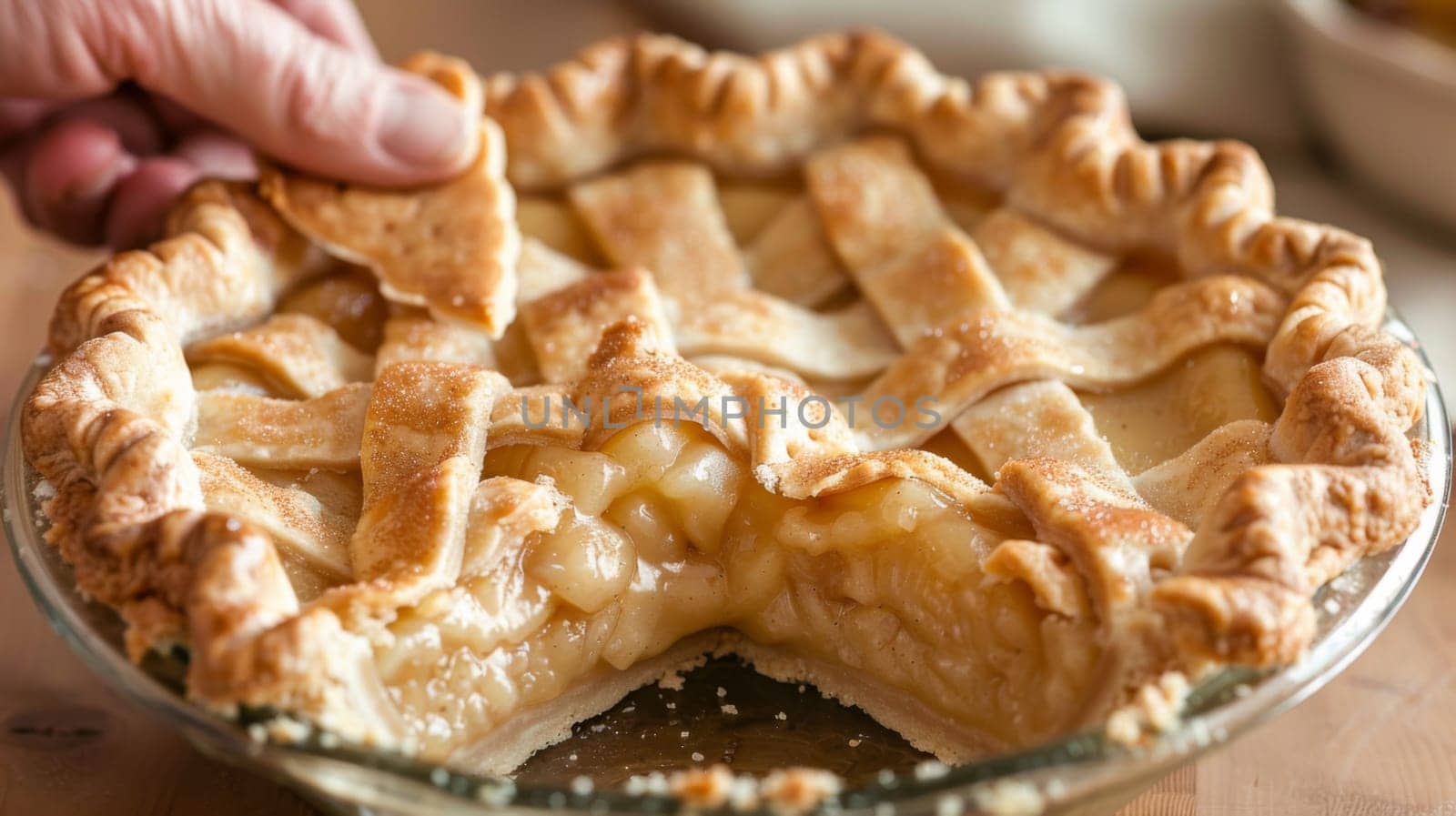 A person is holding a piece of pie with their finger