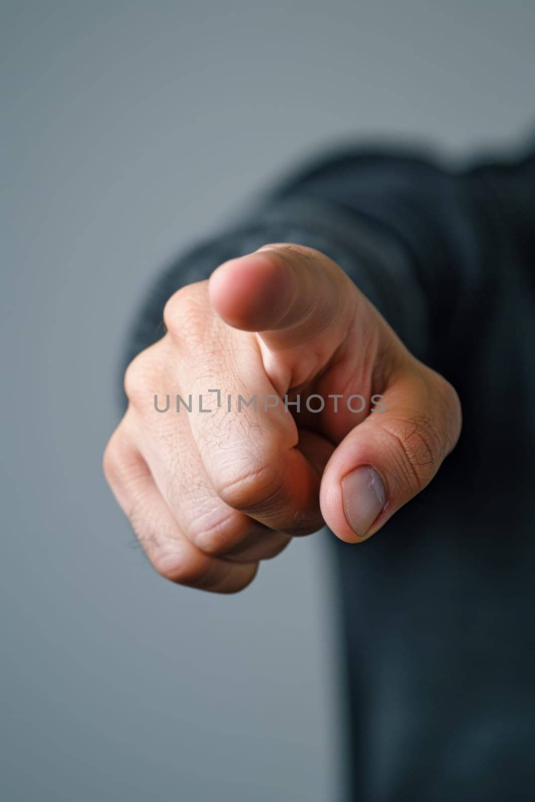 A man pointing at something with his finger on the trigger