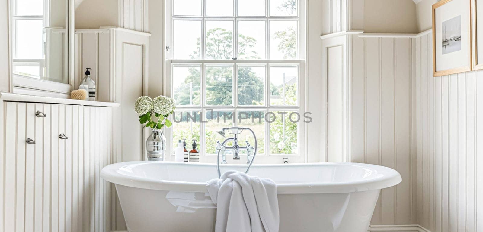 Interior of white bathroom with a bathtub and a mirror and window view by Olayola