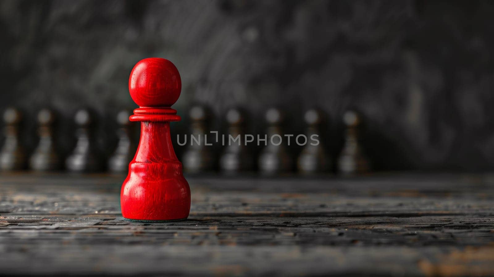 A red chess piece on a table in front of black pawns