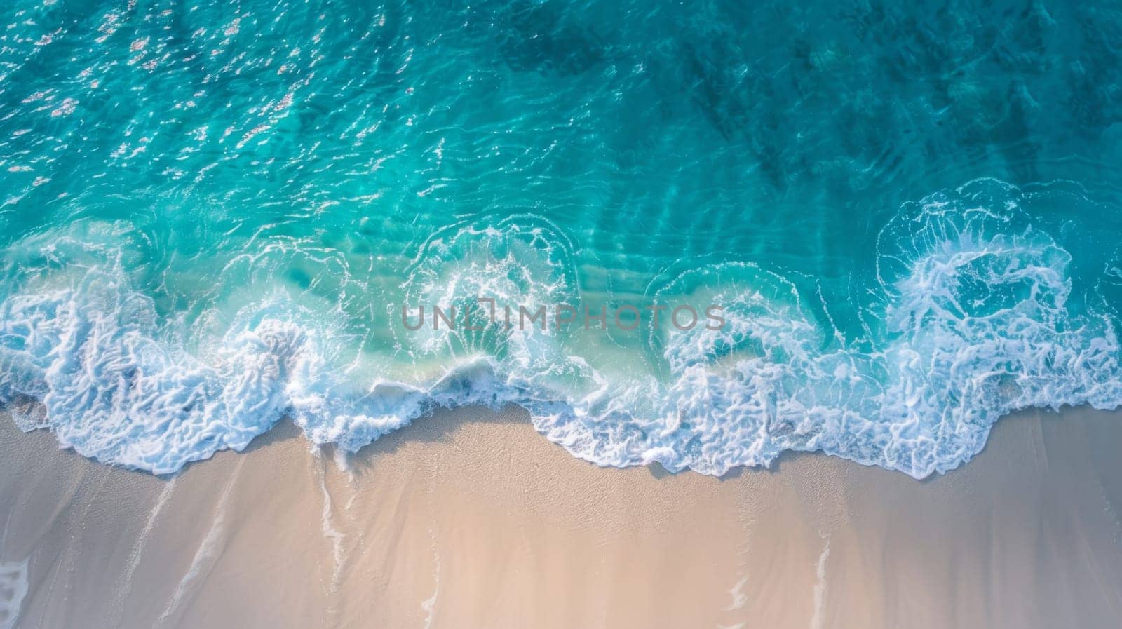 An aerial view of a beach with waves and sand