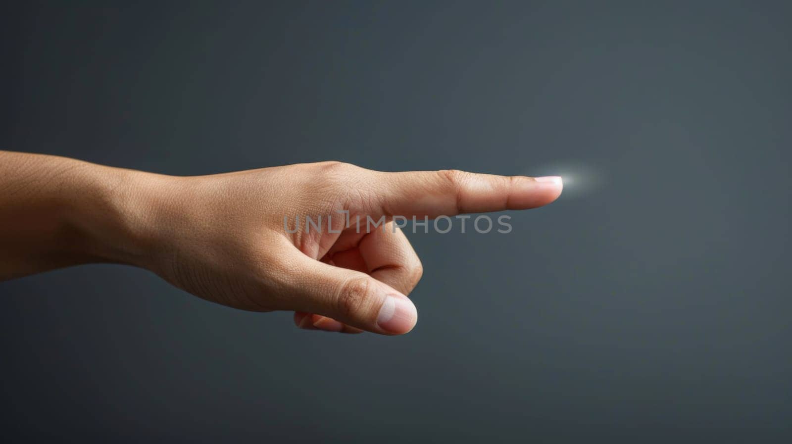 A hand pointing at something with a light coming from it