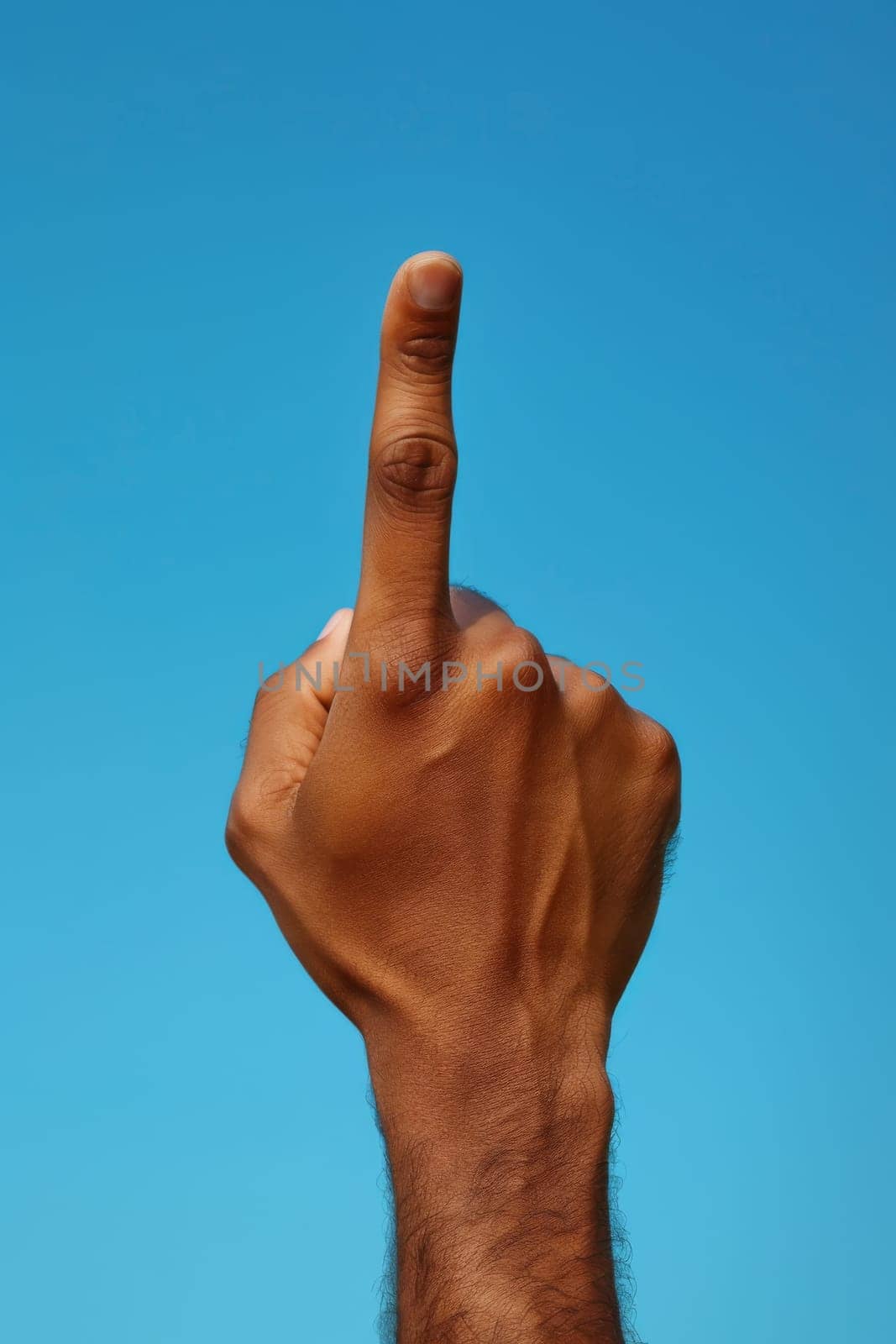 A man's hand is up in the air with a finger pointing
