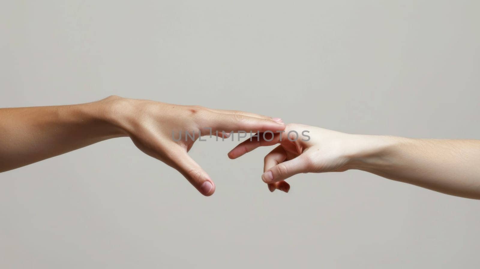 Two hands reaching for each other with a gray background