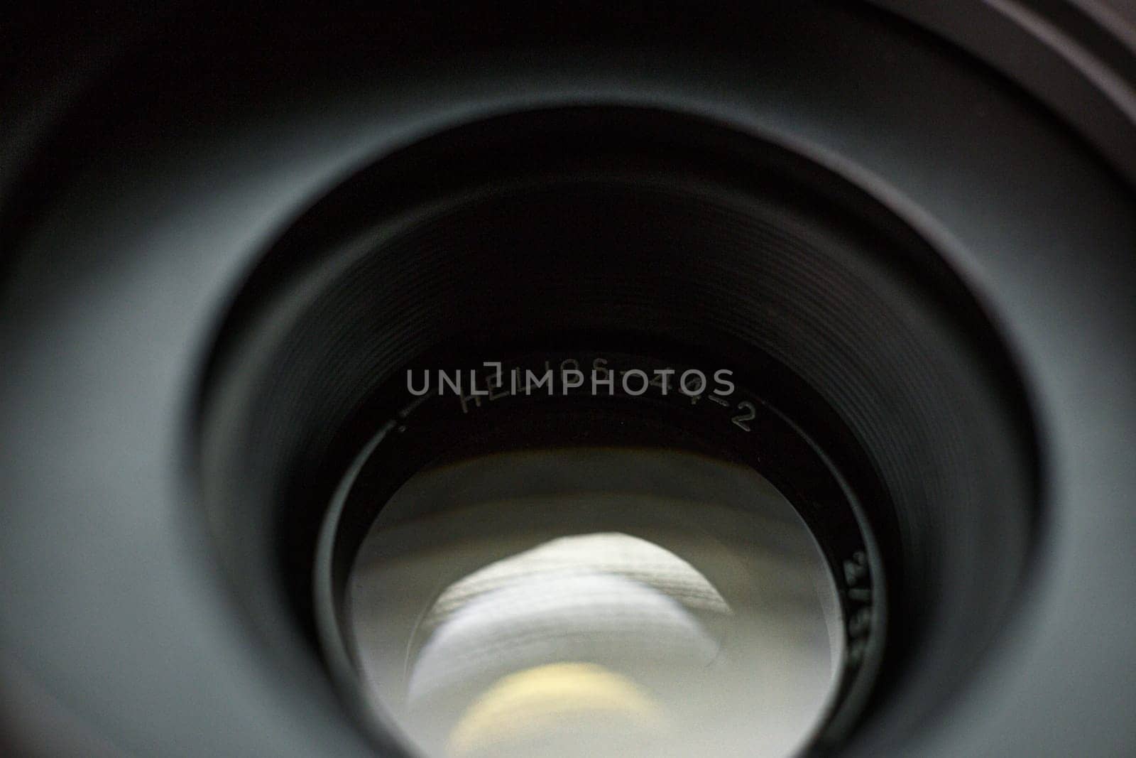 Interior view through Helios 44-2 lens, name engraved on inner ring, light reflection visible, capturing photography equipment intricacies by mosfet_ua
