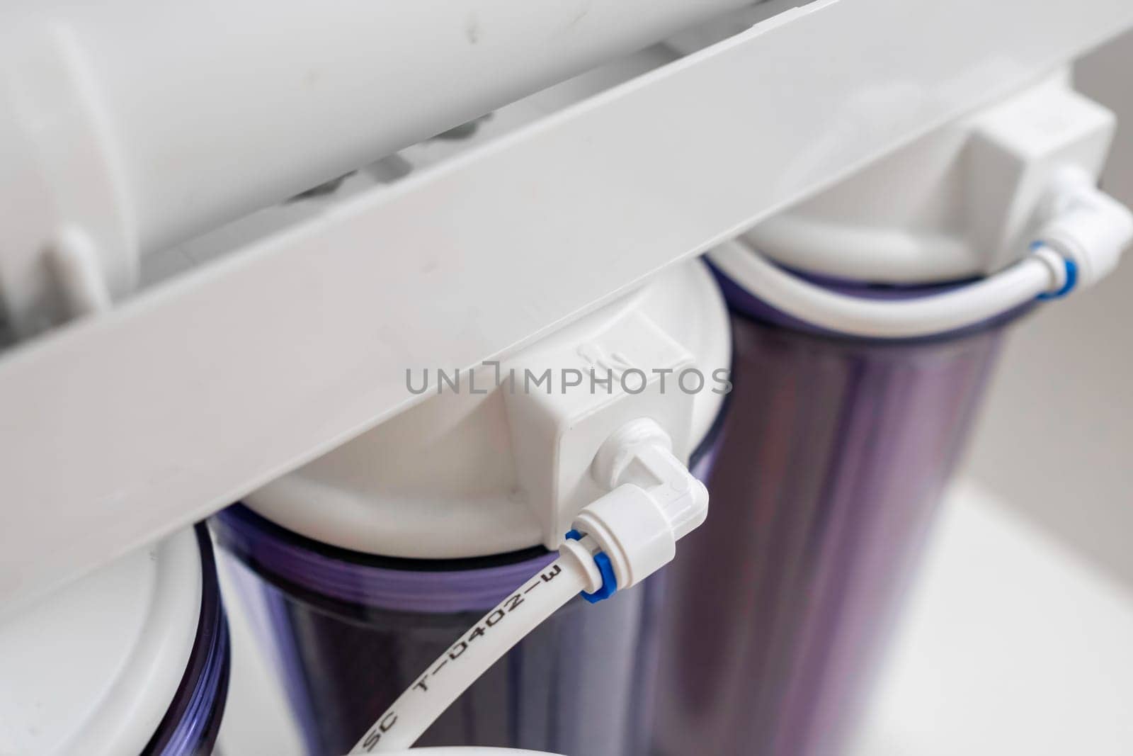 Close up tubes in a reverse osmosis system for water purification at home.