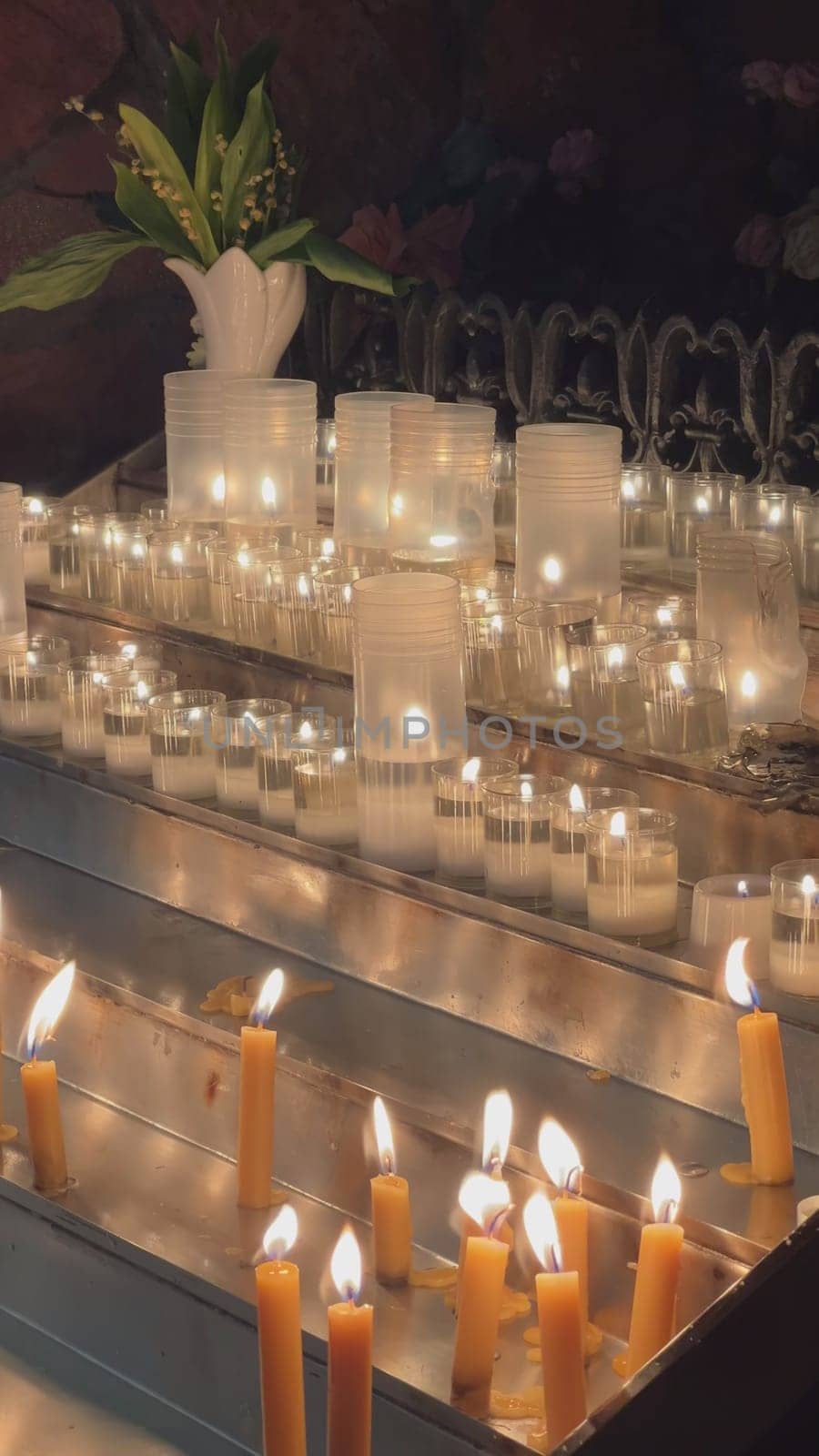 Candles are lit in the Catholic Church. Vertical video for the smartphone. by DovidPro