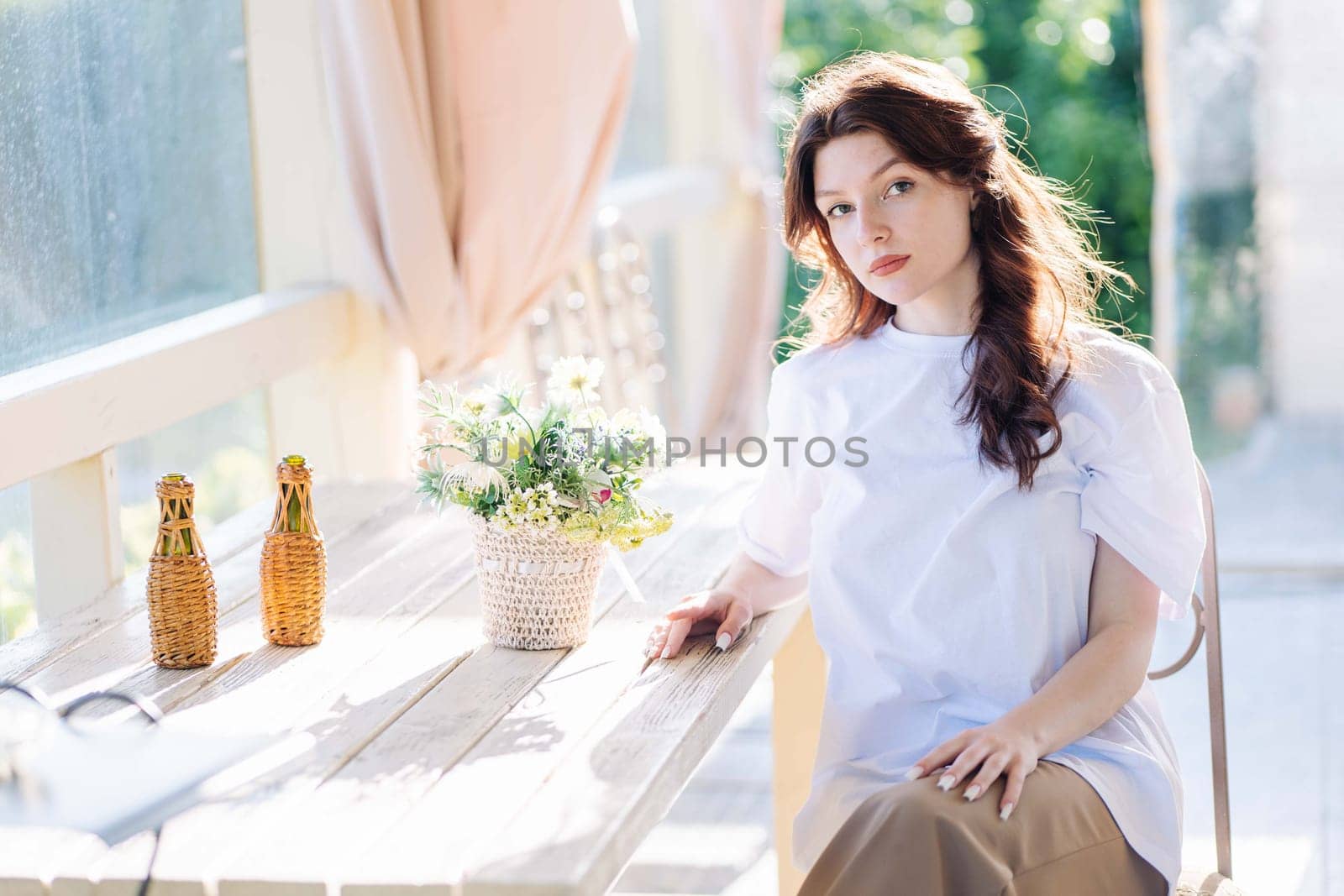 Portrait of a Russian young girl sitting on a chair
