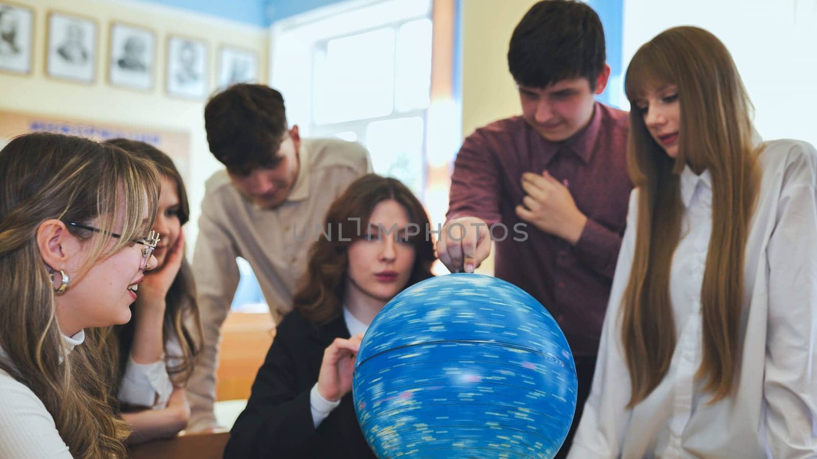 Students look at a globe of the starry sky in a classroom at school