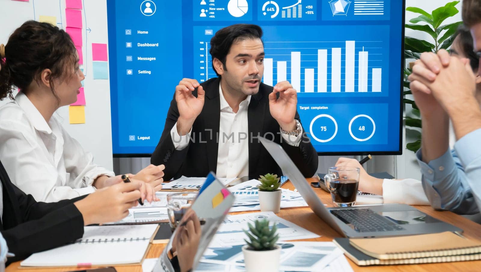 Diverse group of business analyst team analyzing financial data report. Finance data analysis chart and graph dashboard show on TV screen in meeting room for strategic marketing planning. Habiliment