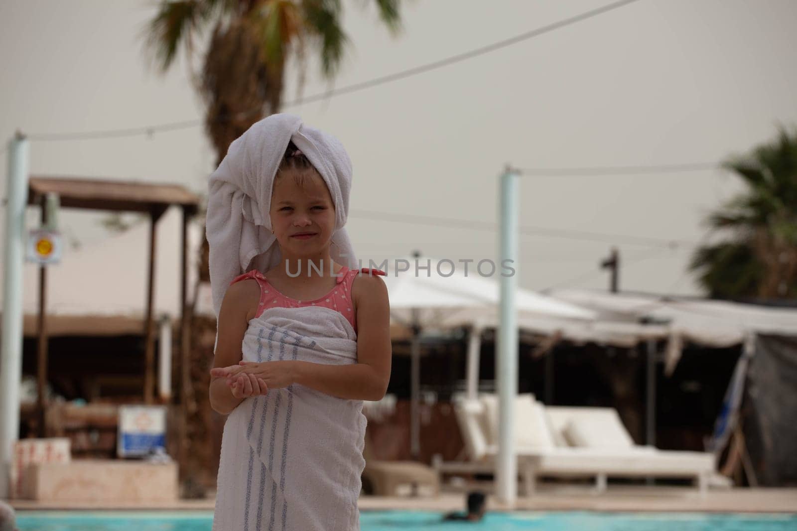 Girl in a towel after swimming in the pool. High quality photo