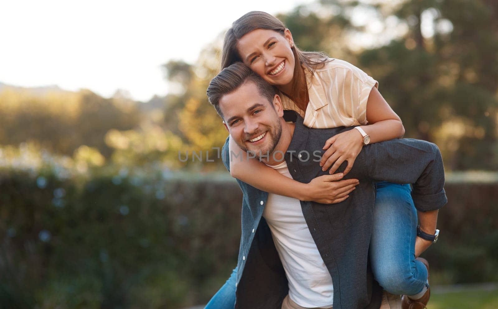 Man, woman and portrait with piggyback in park for relationship connection, anniversary or celebration. Happy couple, face and romance date in nature together for travel exploring, forest or marriage.