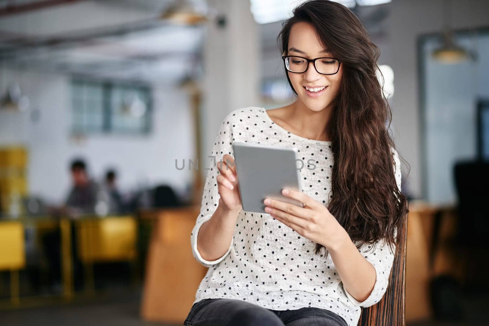 Woman, office and chair with smile on tablet for break on internet or online for research as graphic designer. Employee, happy and browse website for projects, creativity or ideas for design agency.