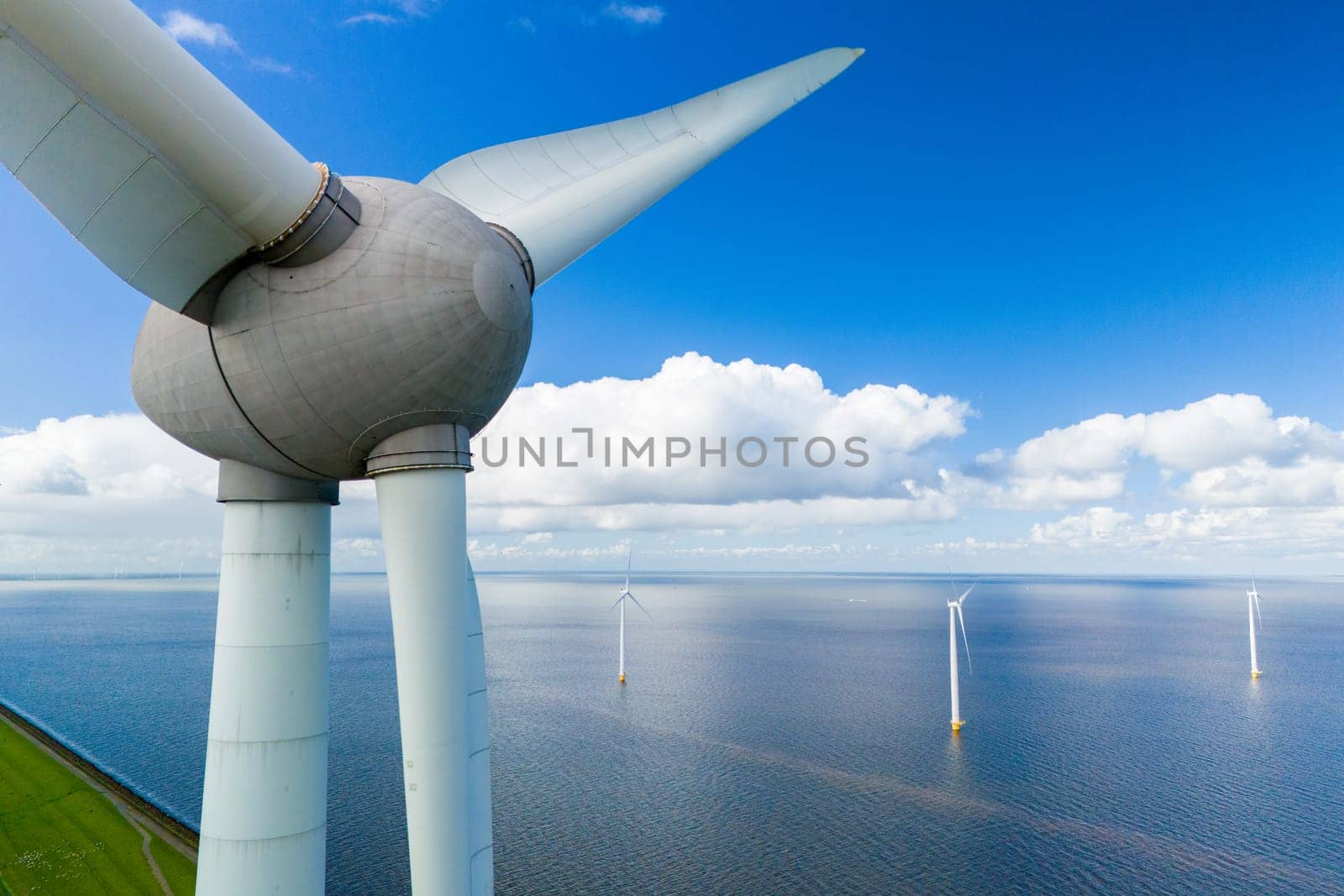 A single wind turbine standing tall in the middle of a large body of water, harnessing energy from the wind to generate electricity by fokkebok