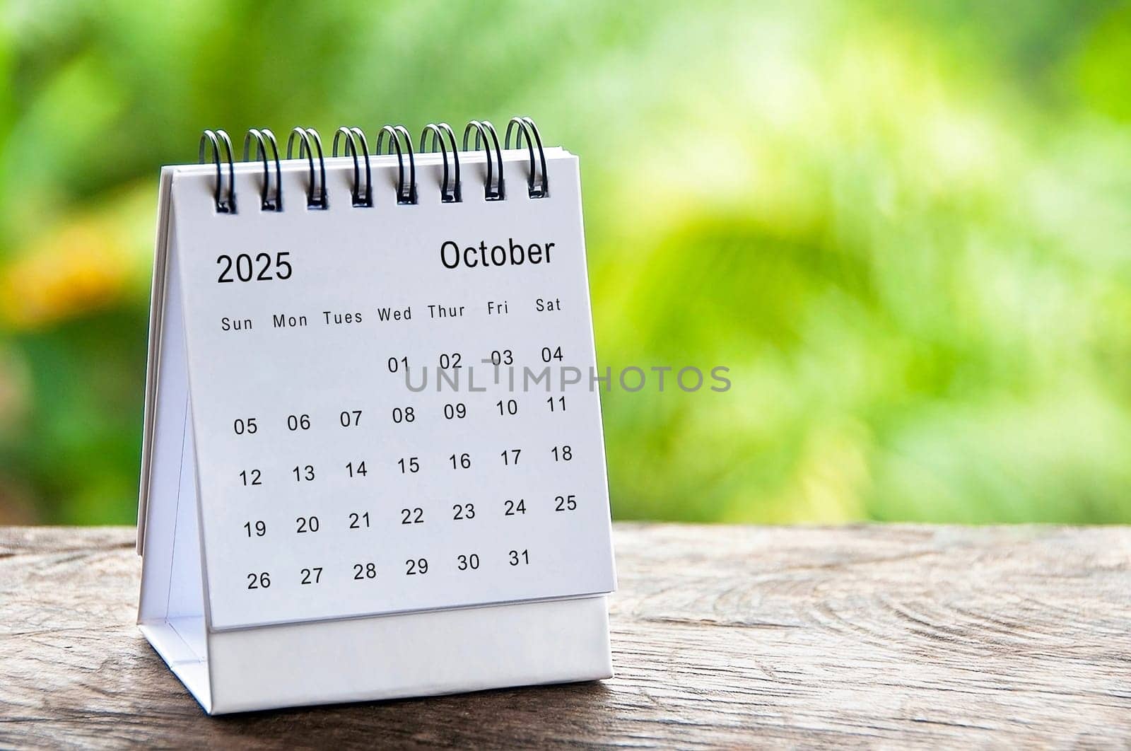October 2025 white table calendar with customizable space for text. Calendar concept and copy space