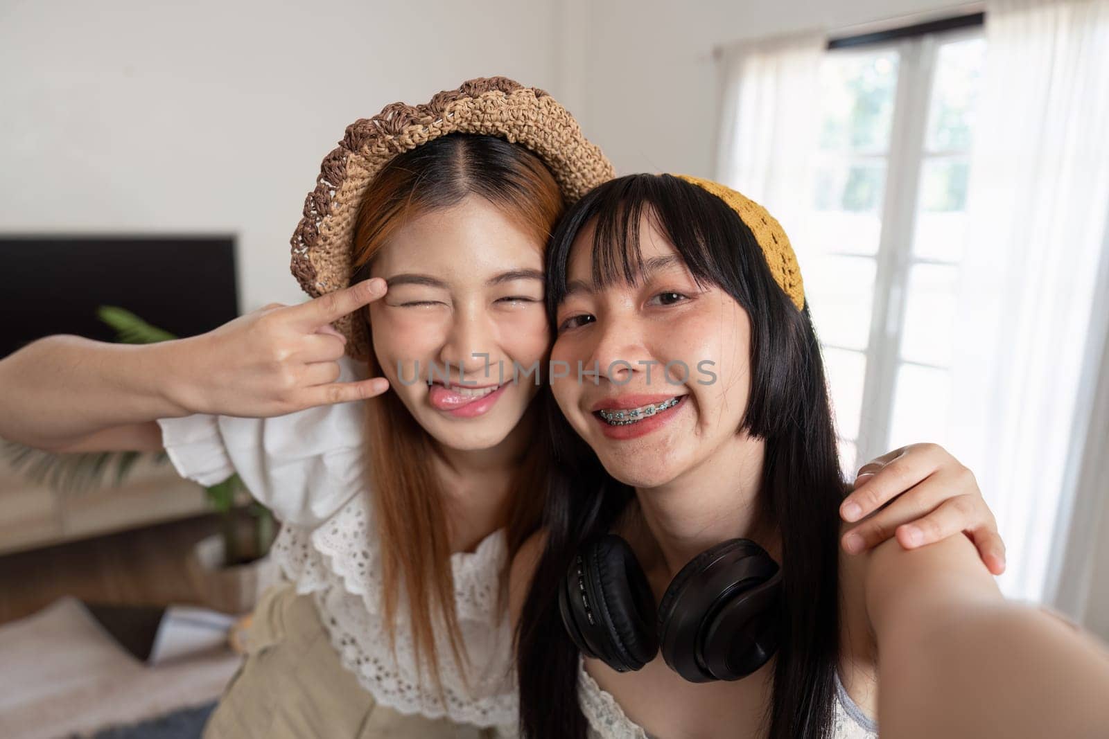 Two Asian woman traveler smile take a photo selfie together. Summer vacation travel concept.
