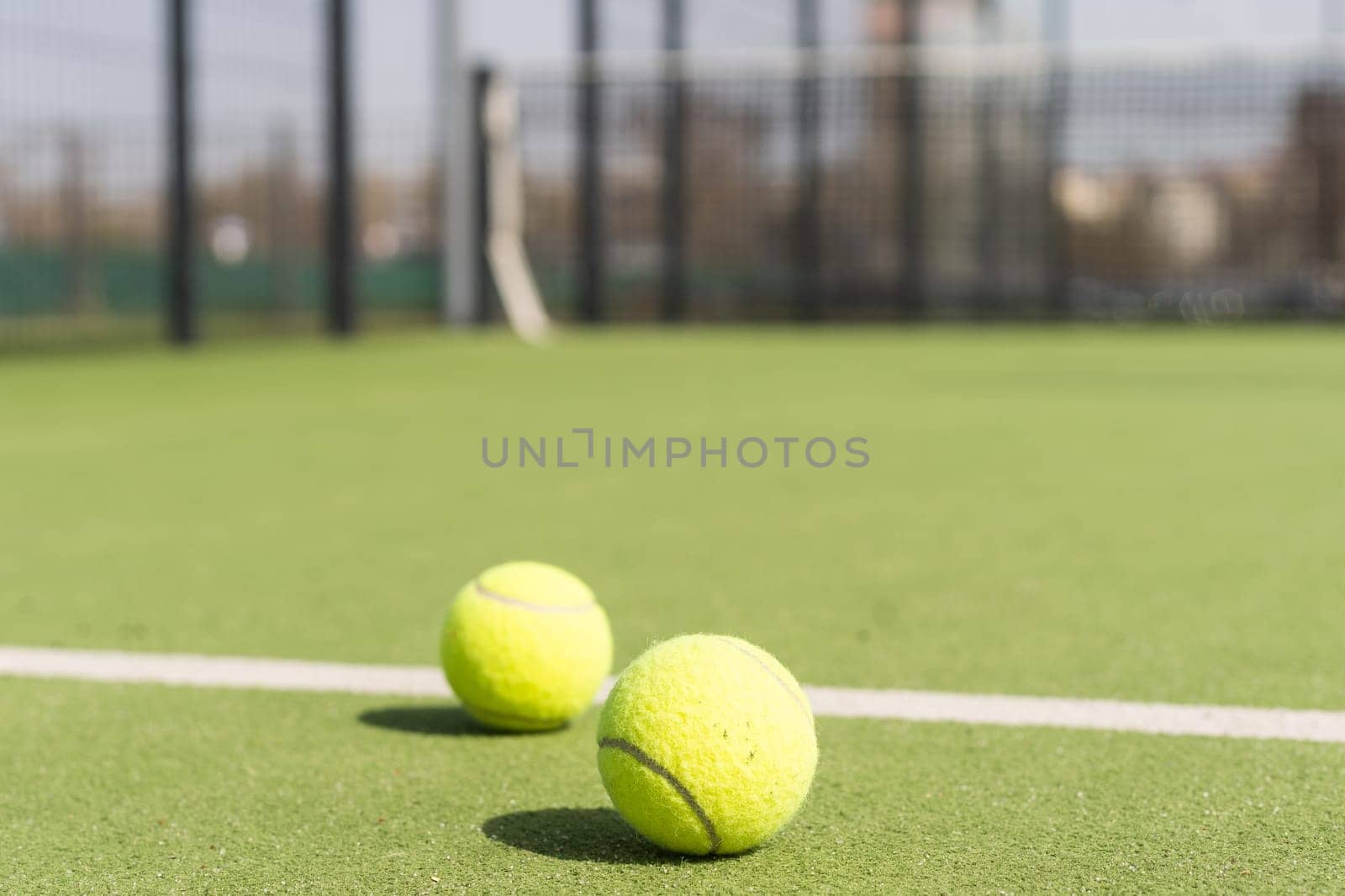 Bright greenish, yellow tennis ball on freshly painted court. High quality photo